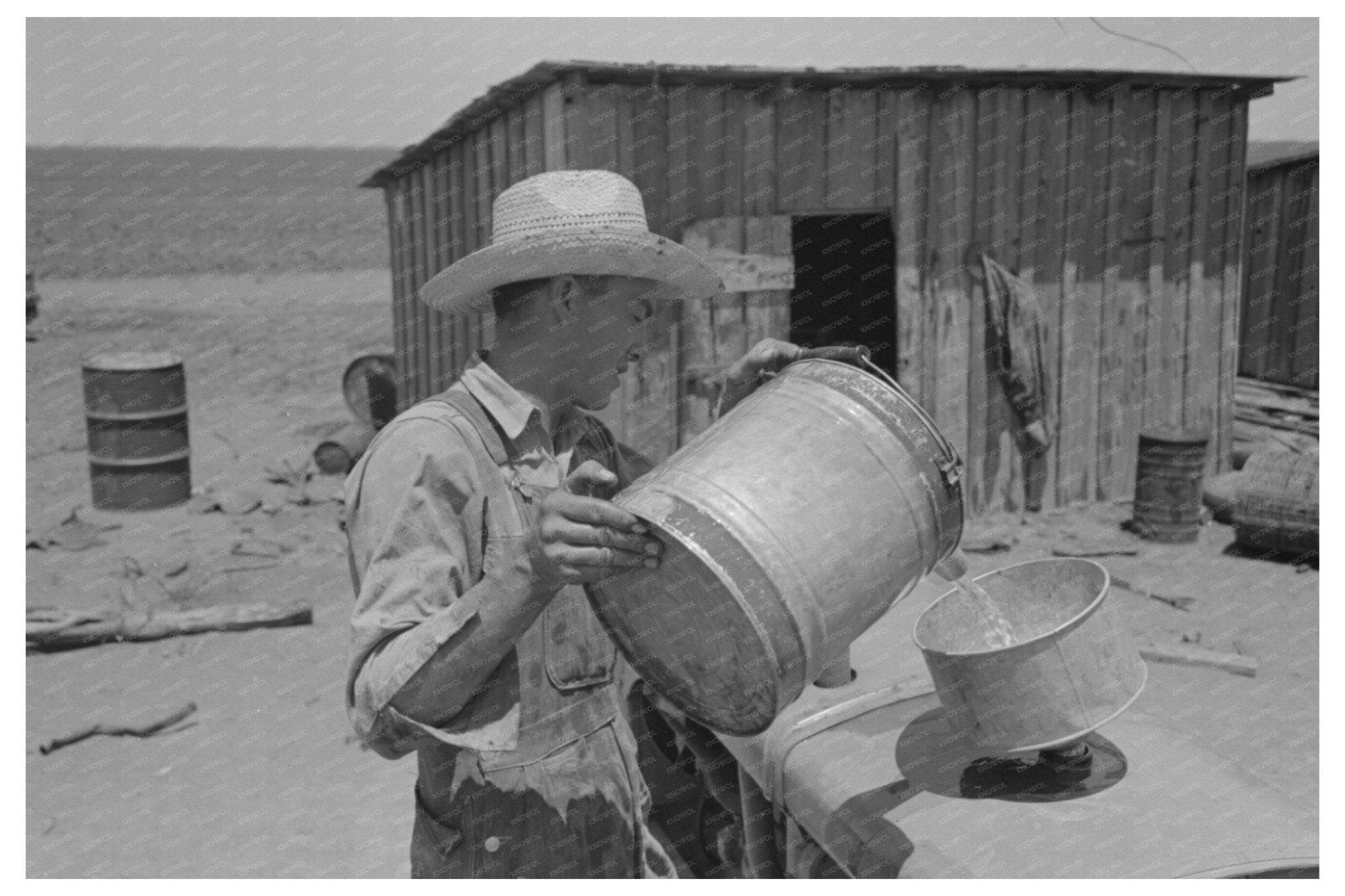 1939 Vintage Photo of Man Pouring Gasoline into Tractor - Available at KNOWOL