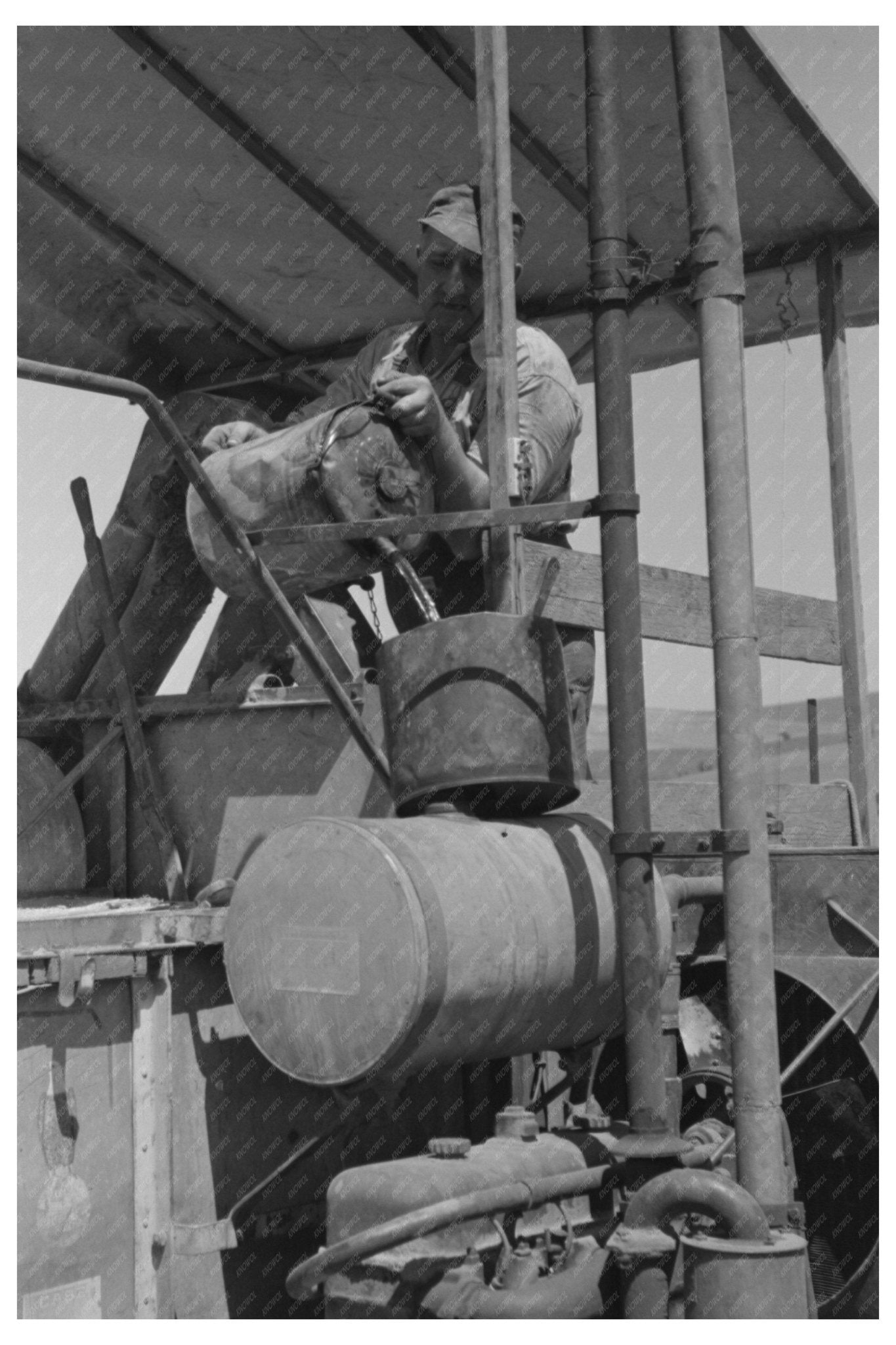 1941 Vintage Image of Worker Fueling Combine Engine - Available at KNOWOL