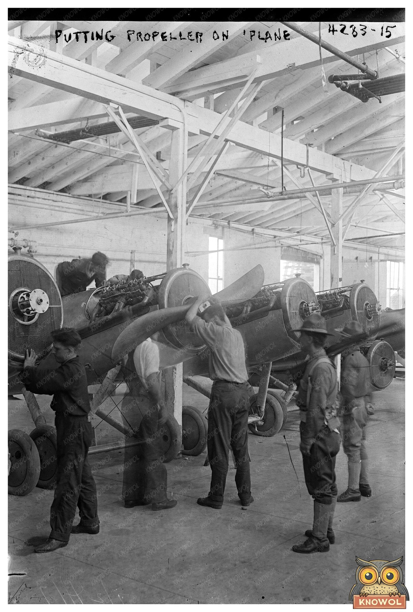 1917 Moment: Worker Fitting Propeller on Vintage Plane