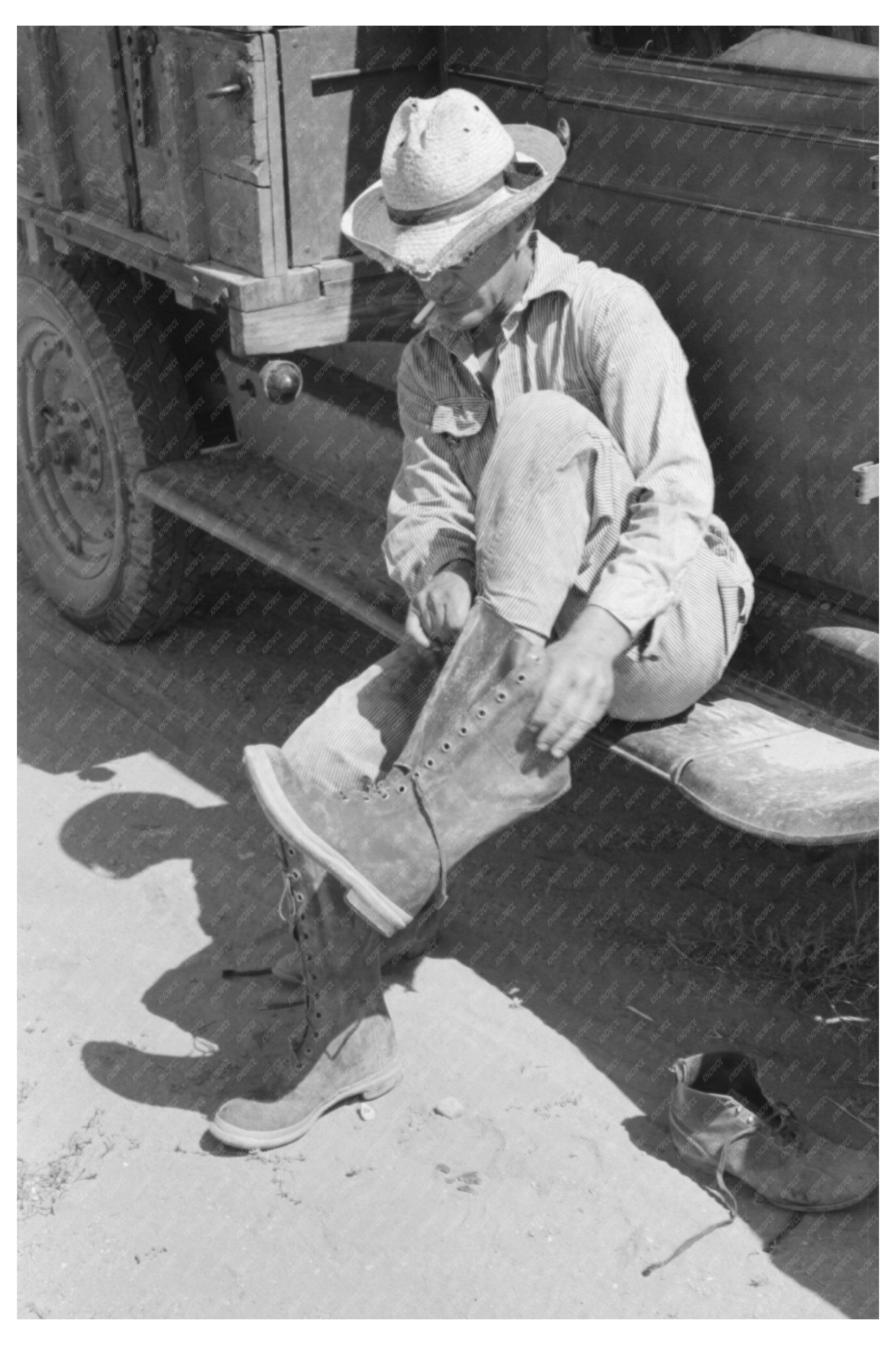 Mr. Johnson Putting on Boots Near Syracuse Kansas 1939