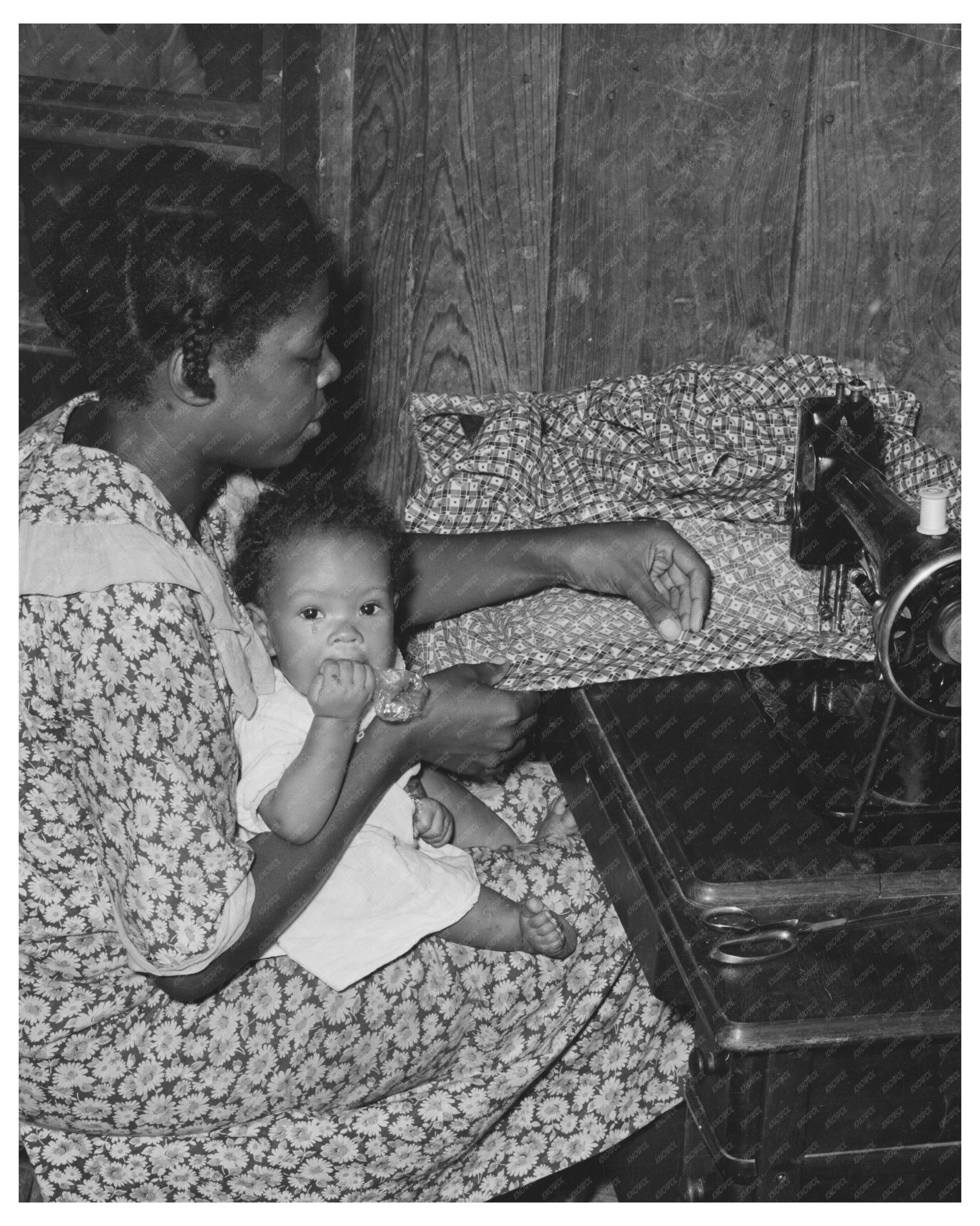 Sharecroppers Wife Sewing with Baby August 1938 Missouri