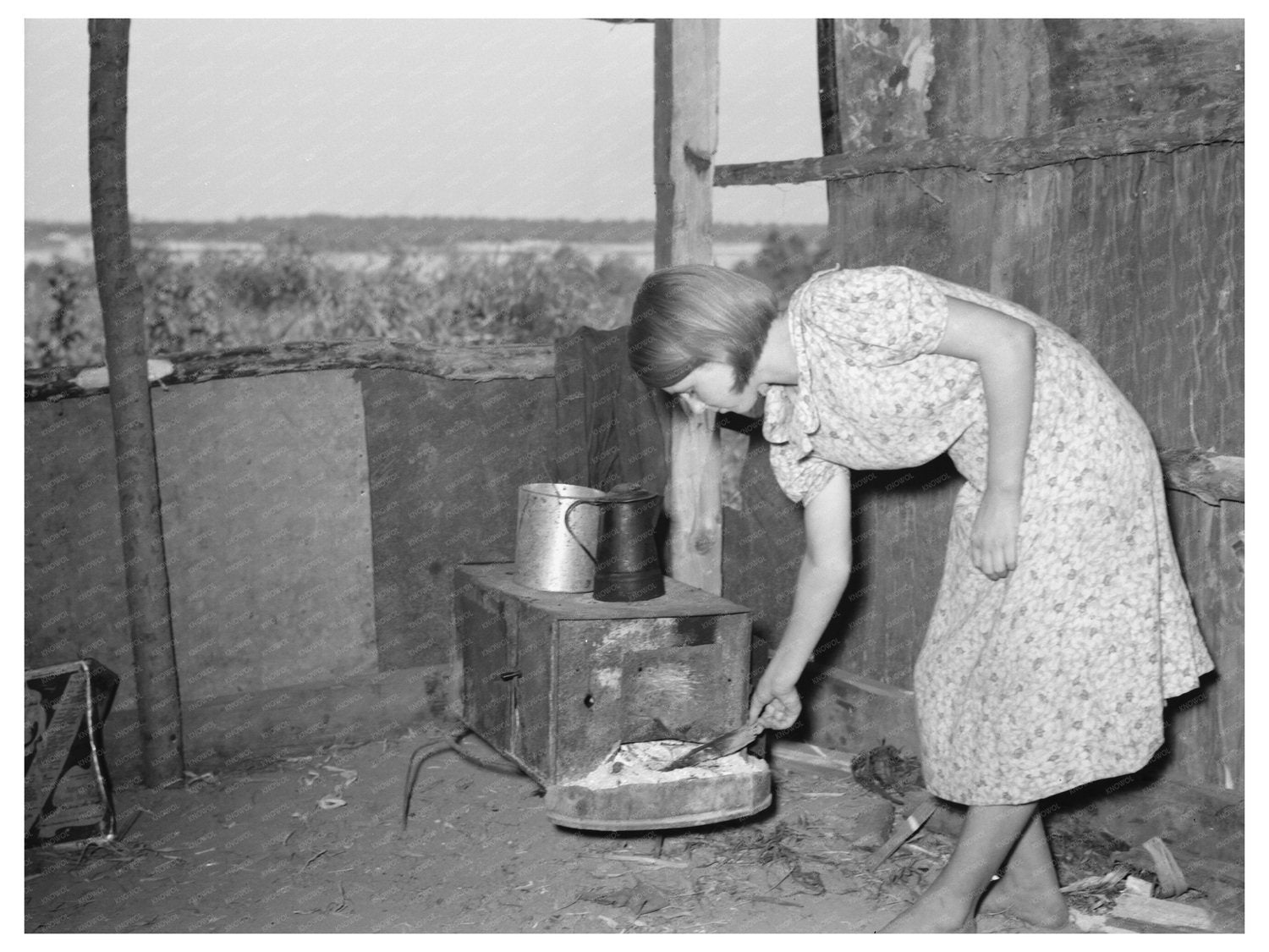 Girl Tending Fire in Tin Shack Caruthersville 1938