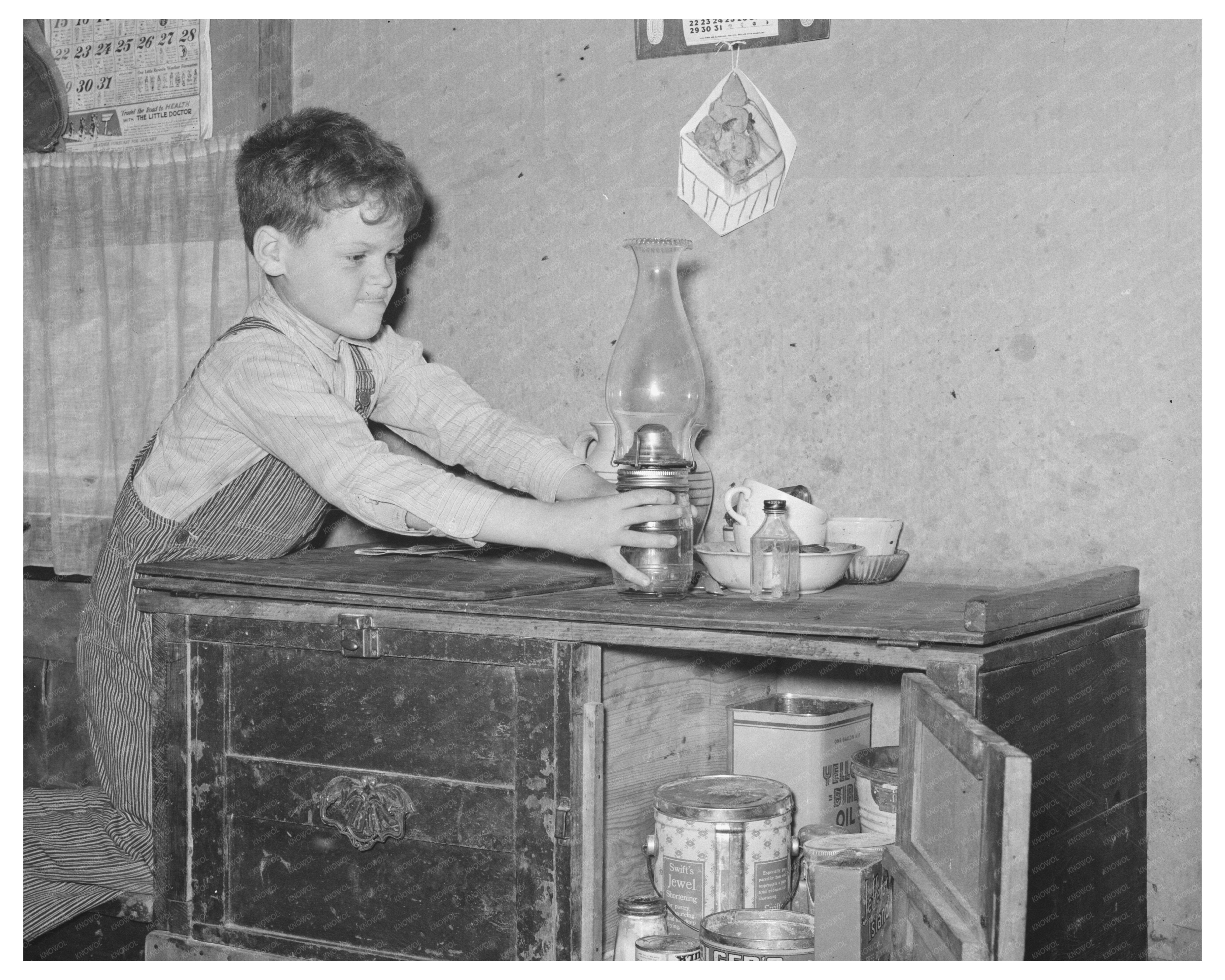 Boy Reaching for Lamp in Texas Trailer Home 1939
