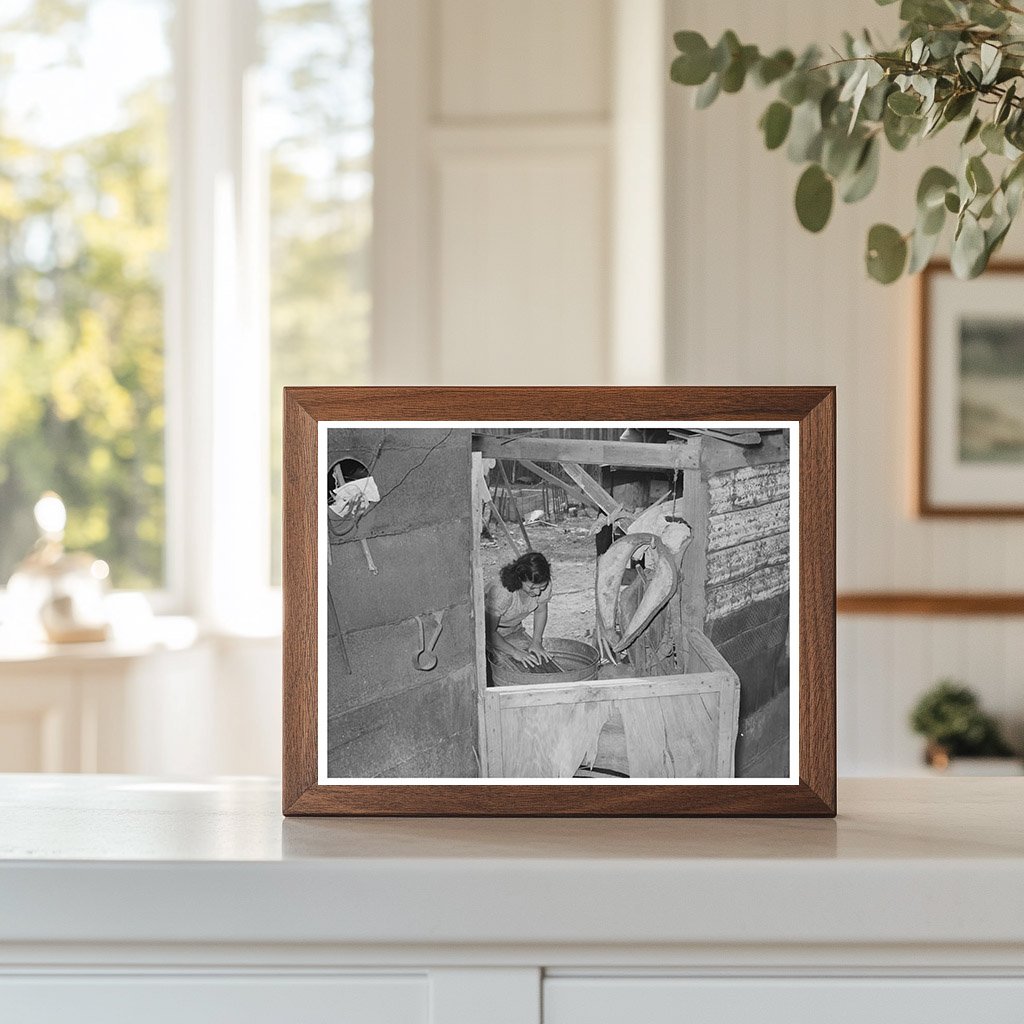 Mexican woman washing clothes in back of house. Sa