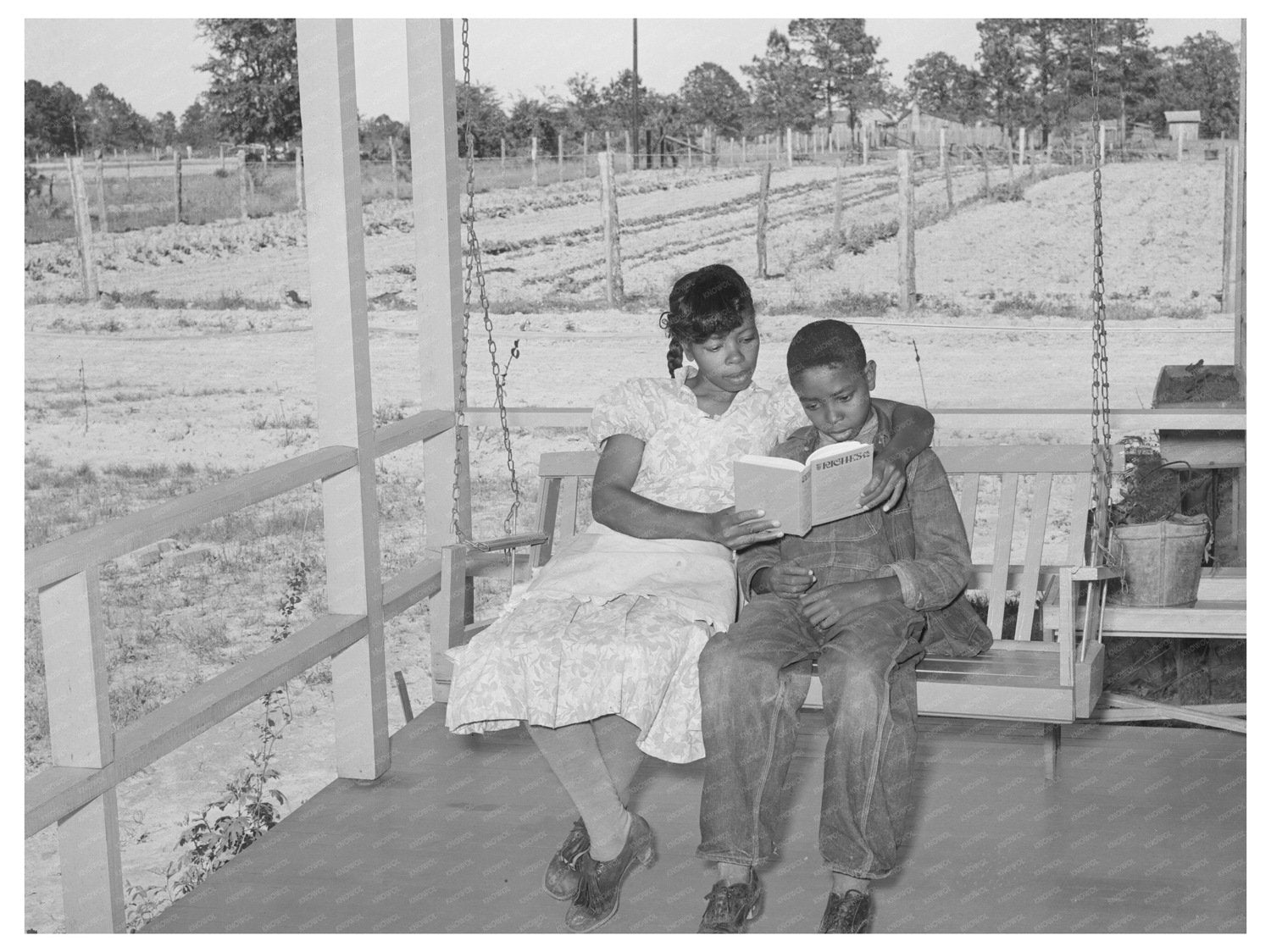 Woman Reading to Son on Porch Swing April 1939