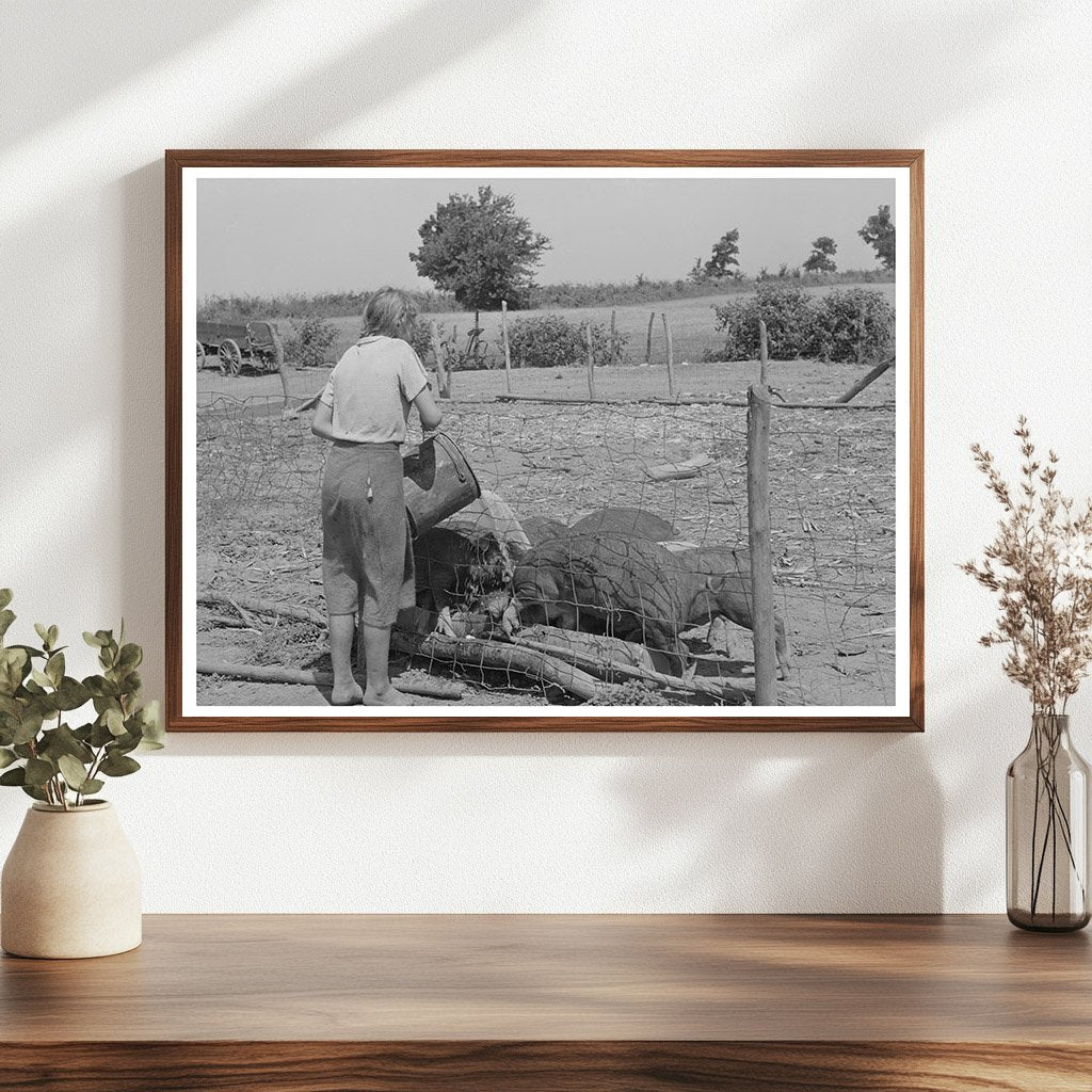 Daughter of Tenant Farmer Feeding Hogs Muskogee 1939
