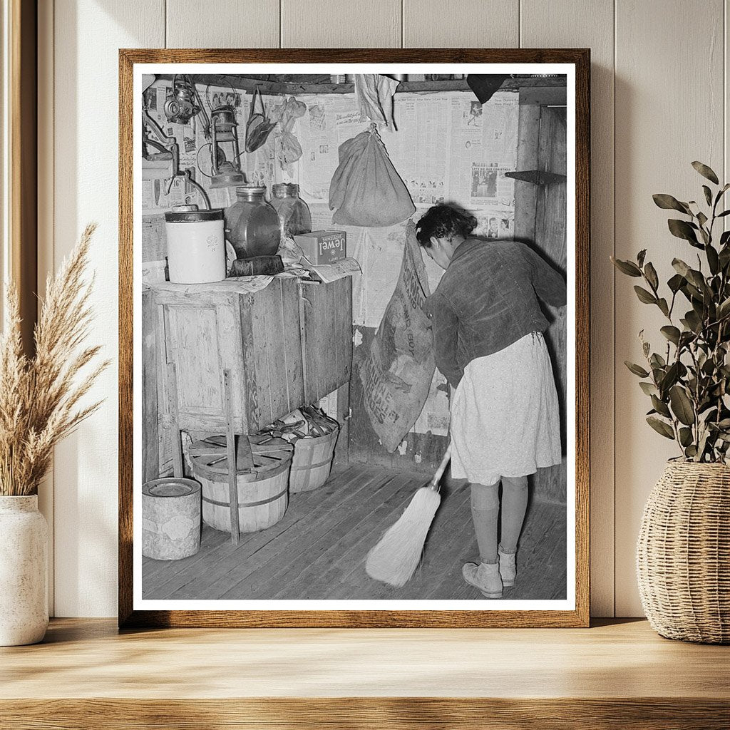 Daughter of Tenant Farmer Sweeping Kitchen February 1944