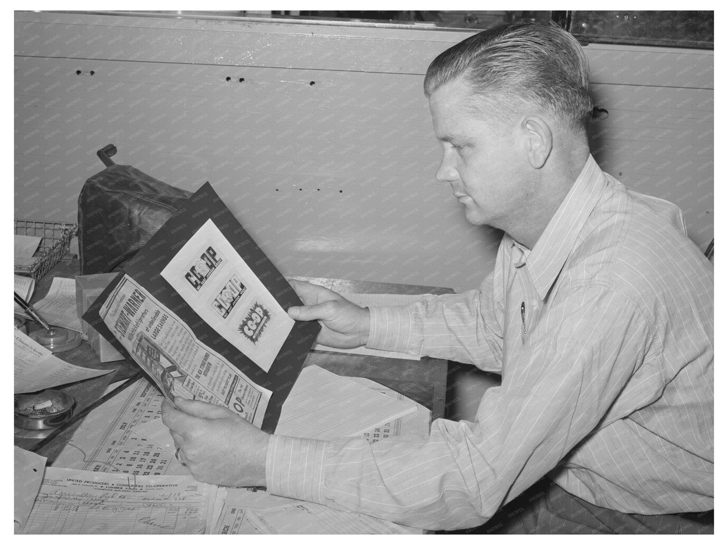 Secretary of United Producers Examining Ads Phoenix 1940