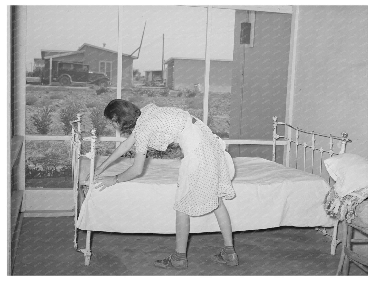 Woman Making Bed on Porch in Casa Grande Valley Farms 1940