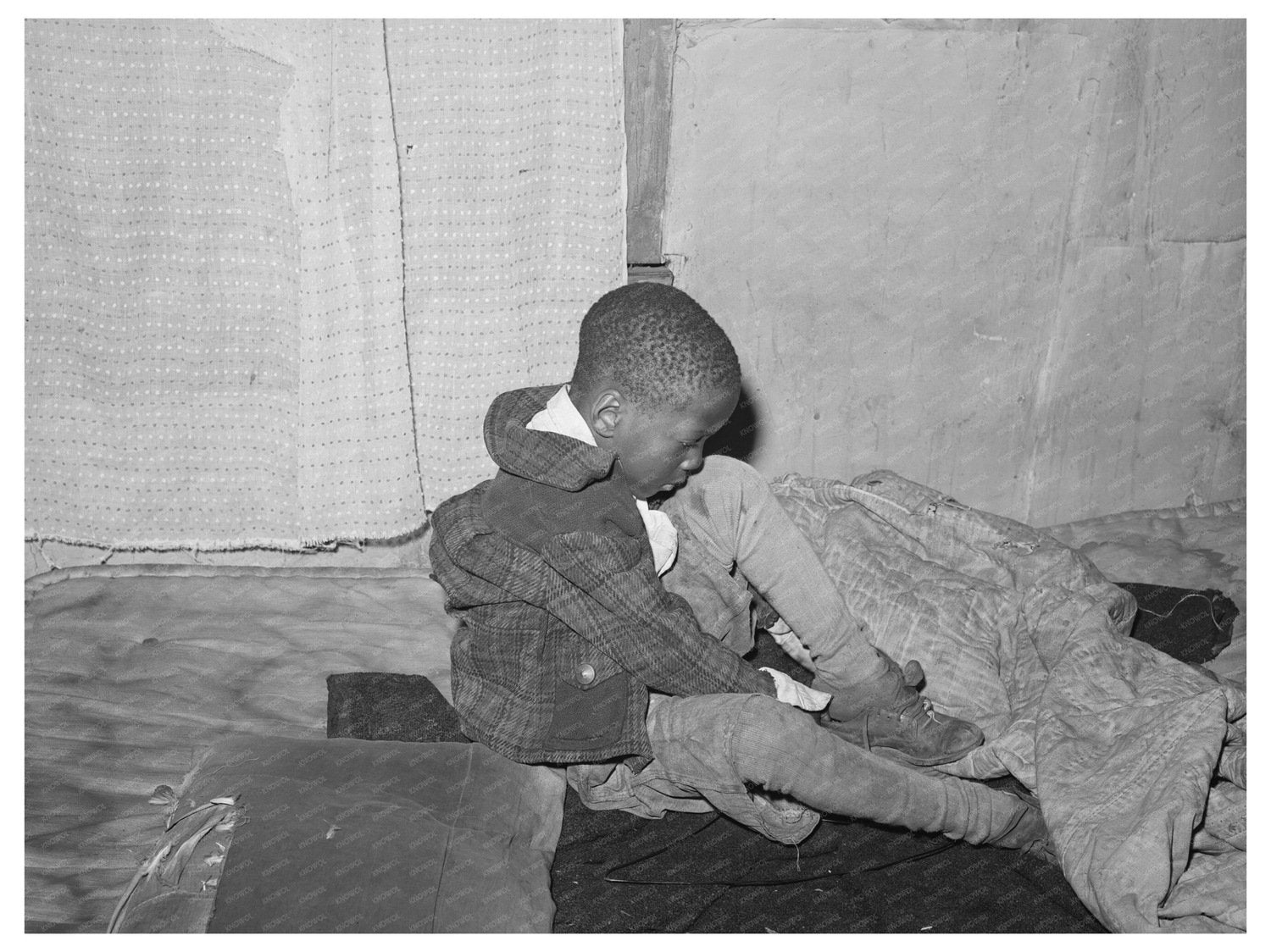 Young Boy Putting on Shoes Chicago April 1941