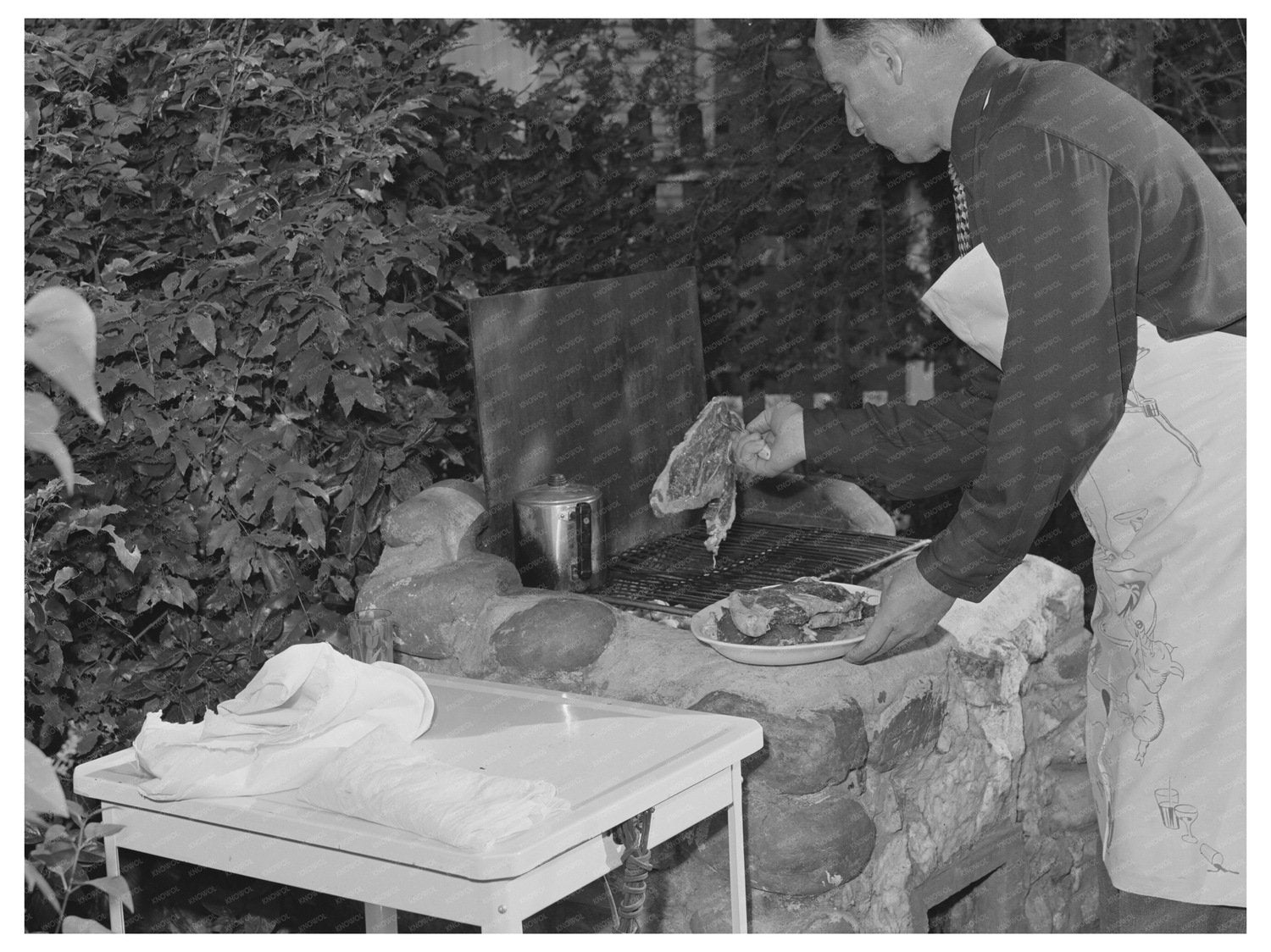 Man Grilling Steaks in Turlock California May 1942