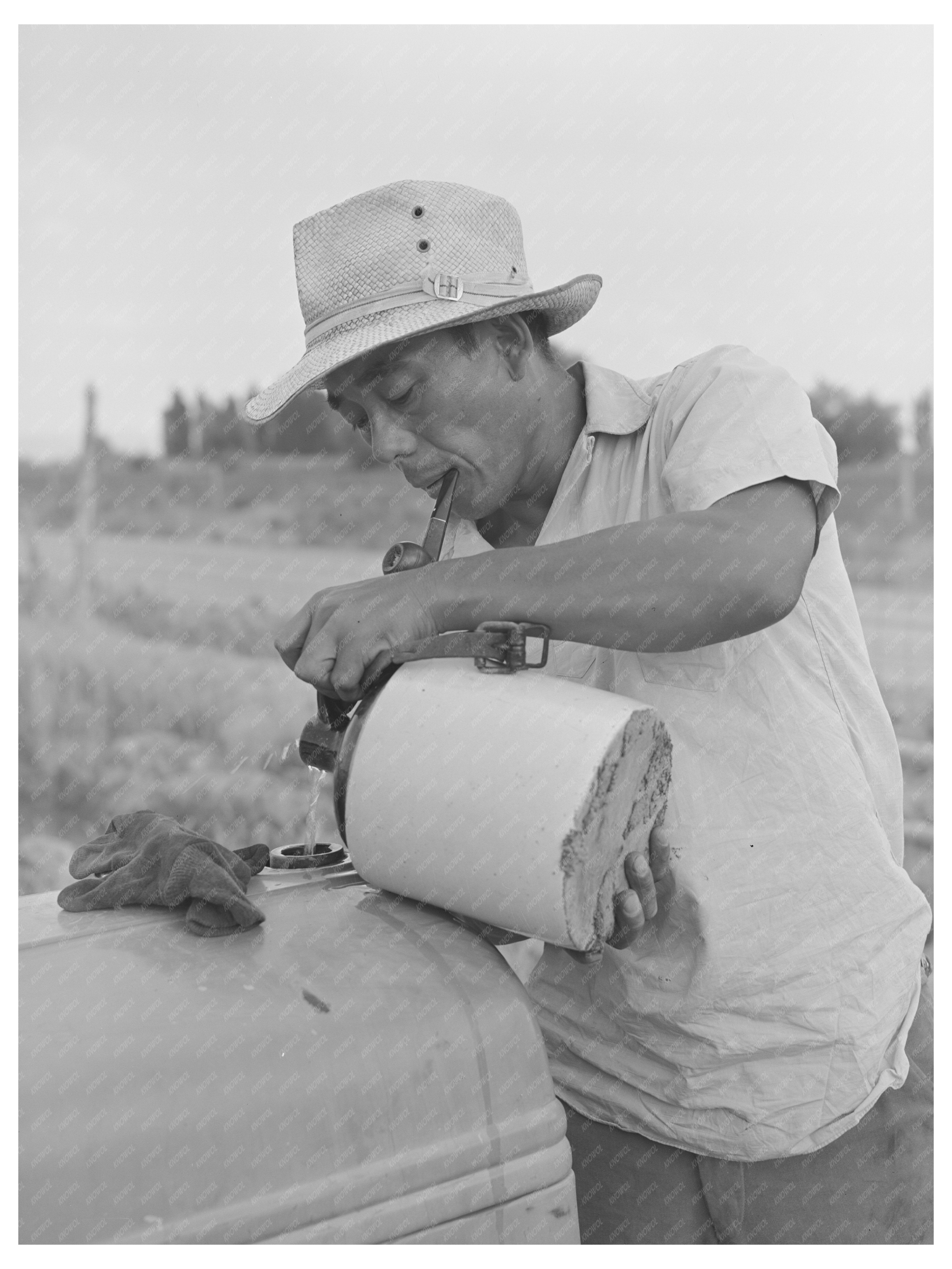 Japanese-American Worker on Tractor Radiator July 1942