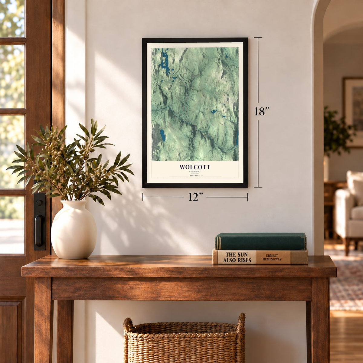 Wolcott, Vermont map, 12 x 18 inch print in a black frame in an entryway