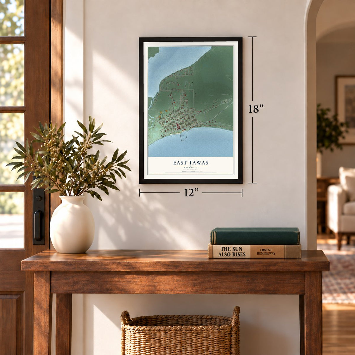 East Tawas, Michigan map, 12 x 18 inch print in a black frame in an entryway