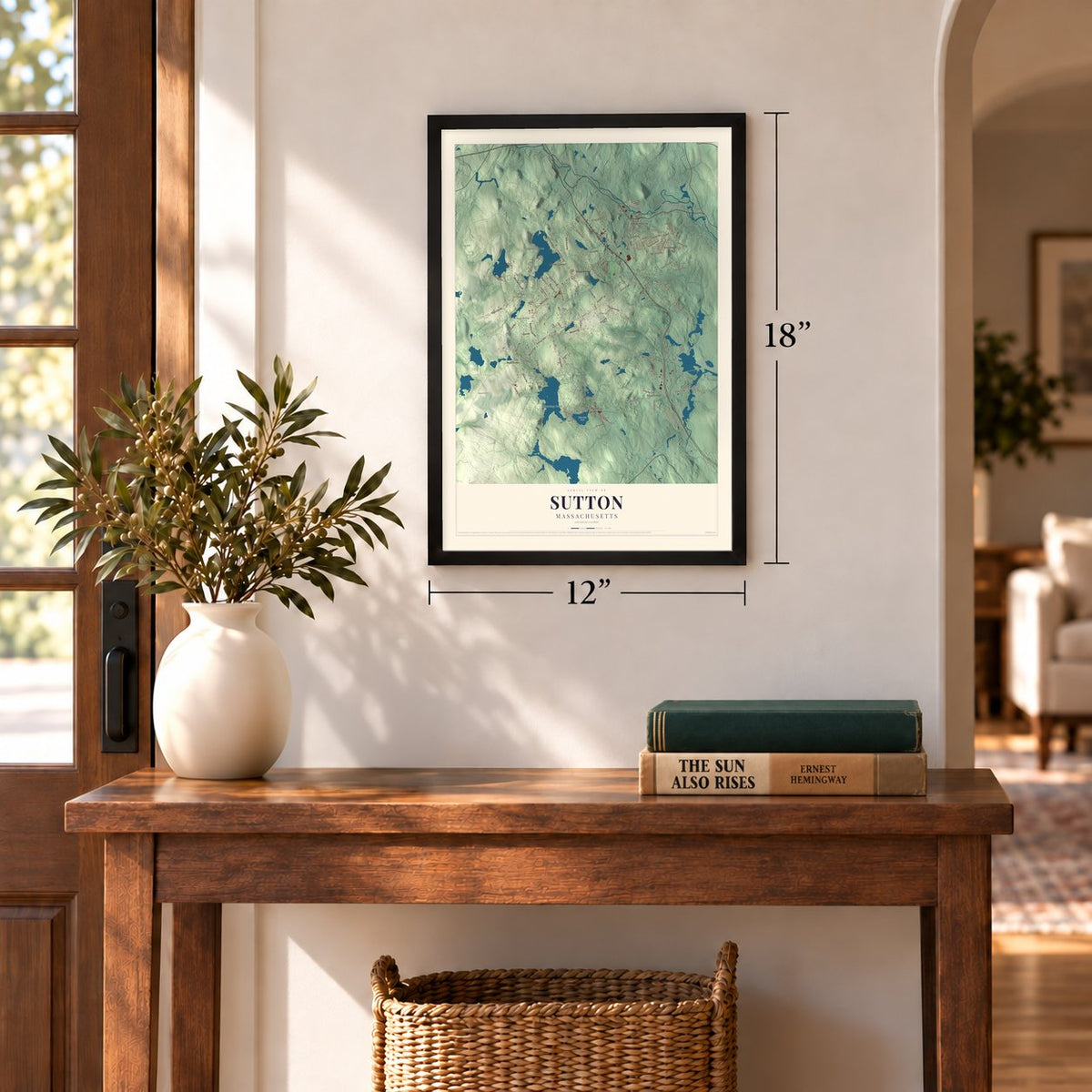 Sutton, Massachusetts map, 12 x 18 inch print in a black frame in an entryway