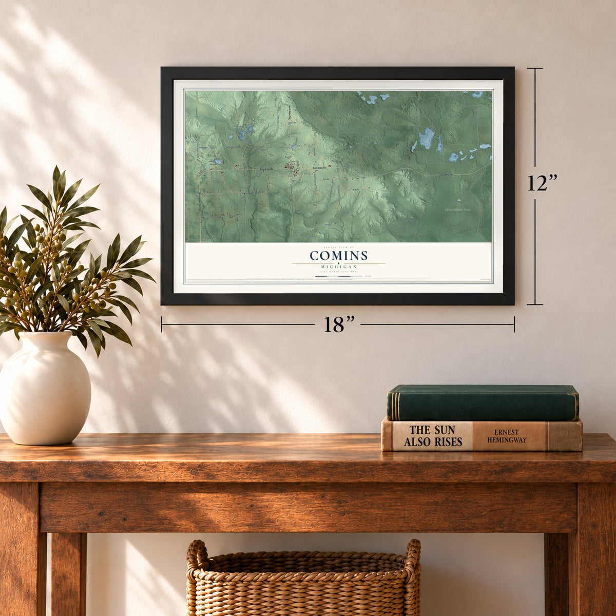 Comins, Michigan map, 12 x 18 inch print in a black frame in an entryway