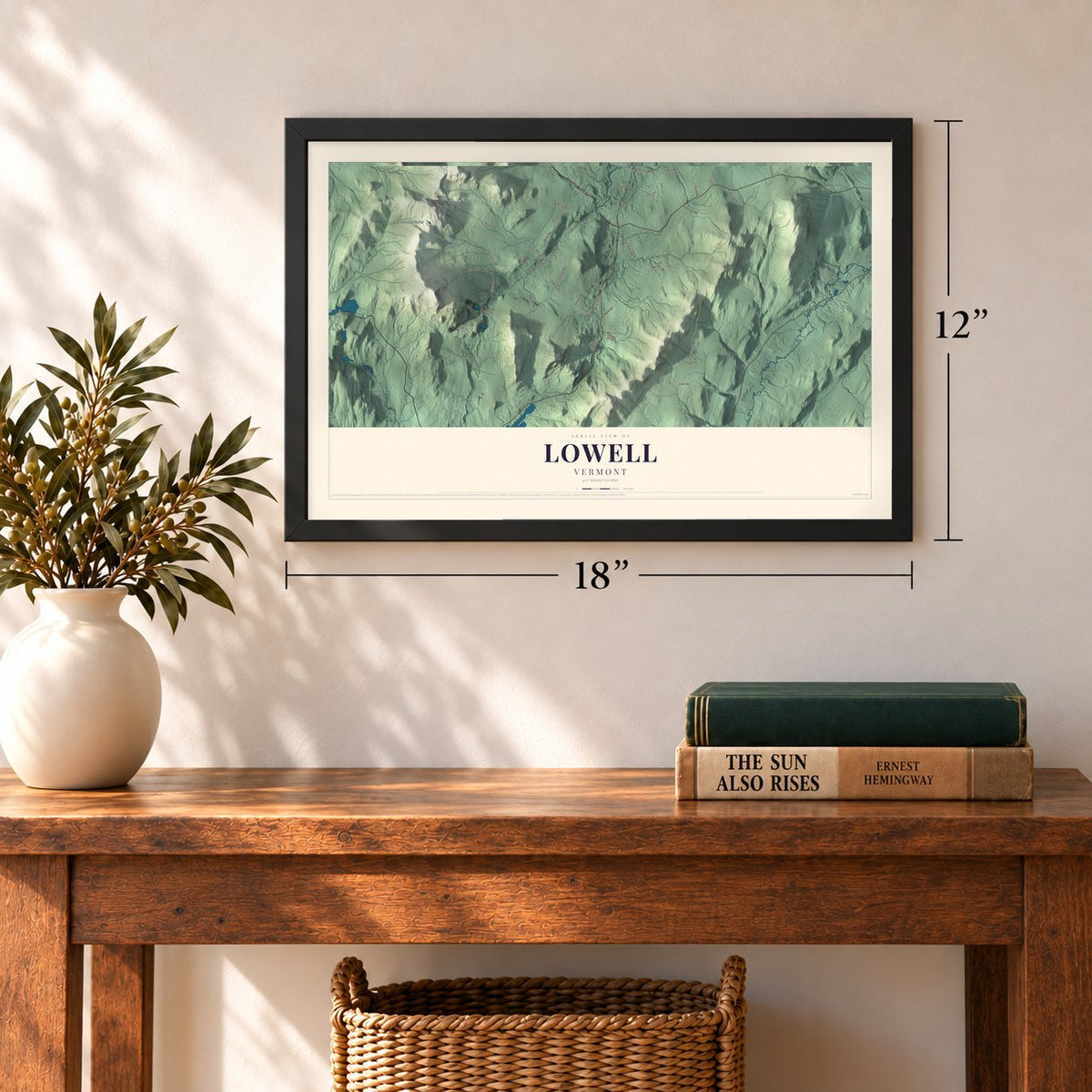 Lowell, Vermont map, 12 x 18 inch print in a black frame in an entryway