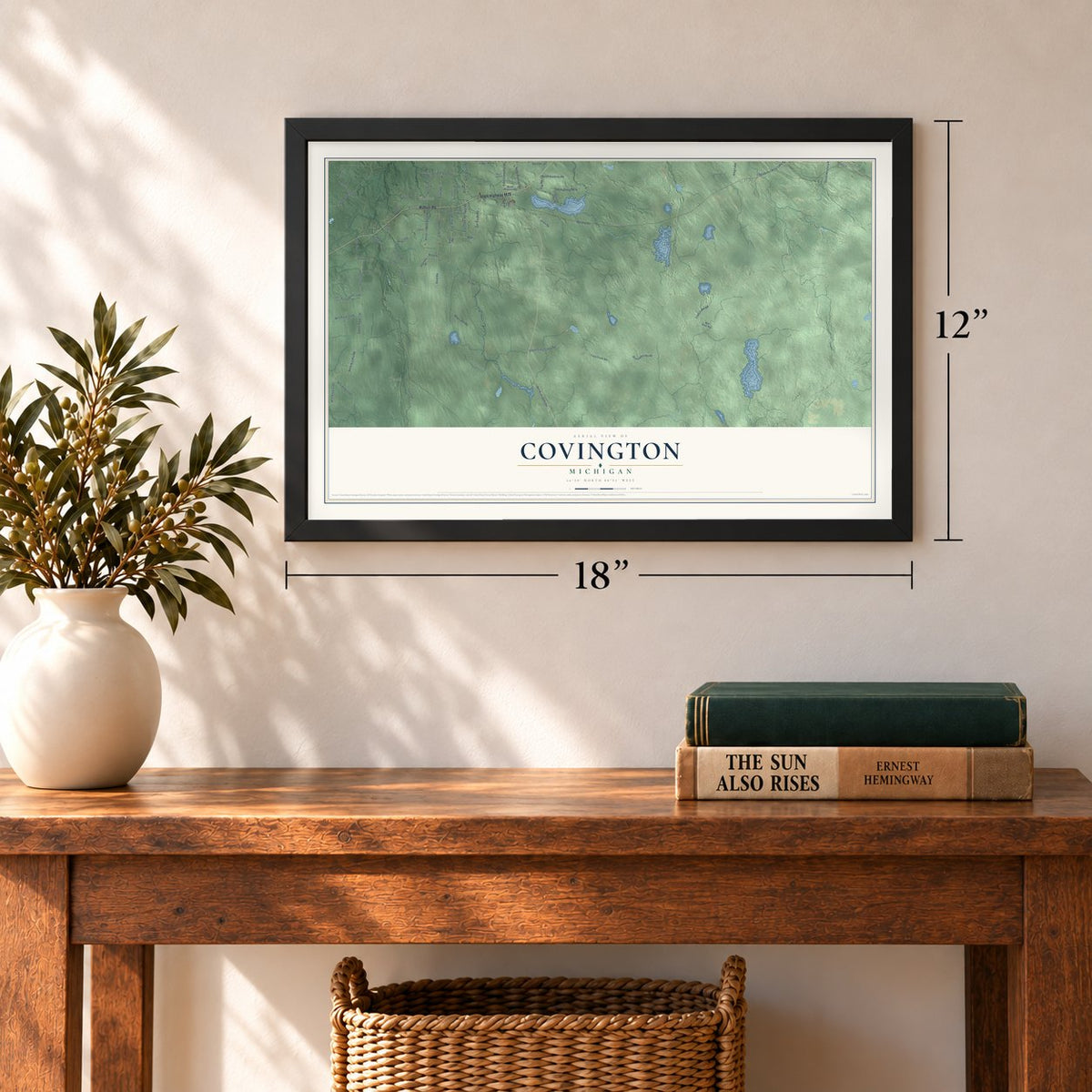 Covington, Michigan map, 12 x 18 inch print in a black frame in an entryway