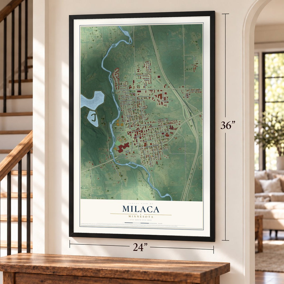 Milaca, Minnesota map, 24 x 36 inch print in a black frame by a staircase
