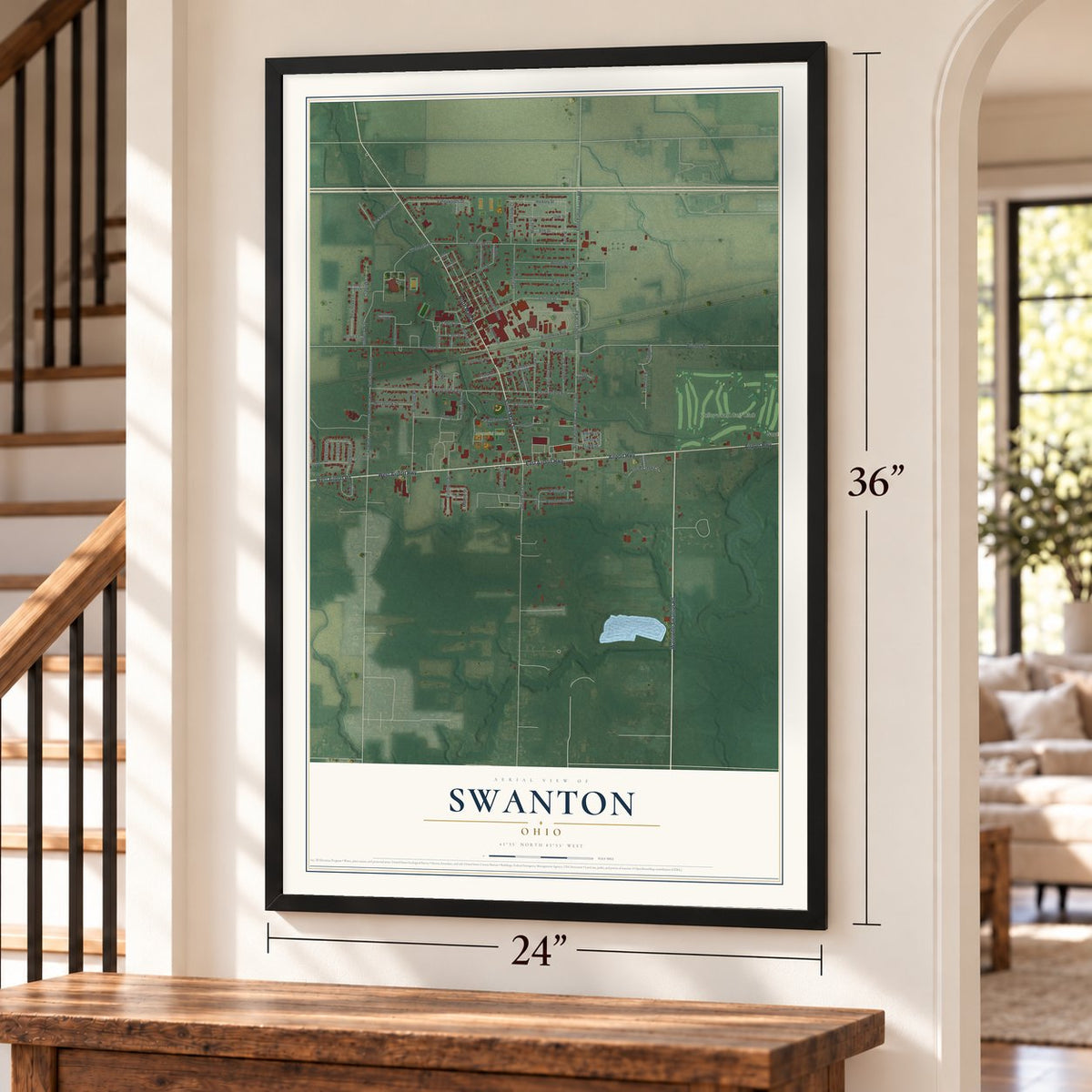 Swanton, Ohio map, 24 x 36 inch print in a black frame by a staircase