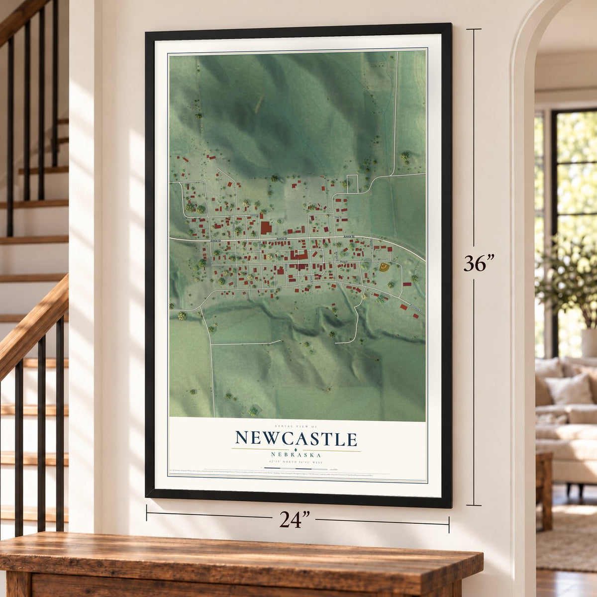 Newcastle, Nebraska map, 24 x 36 inch print in a black frame by a staircase