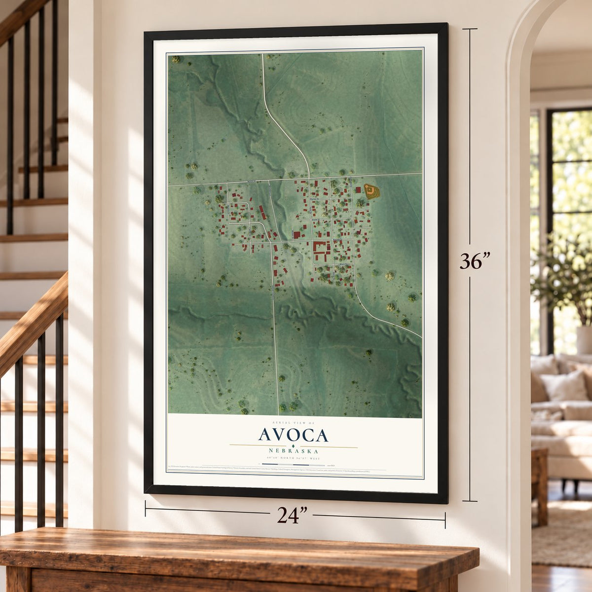 Avoca, Nebraska map, 24 x 36 inch print in a black frame by a staircase
