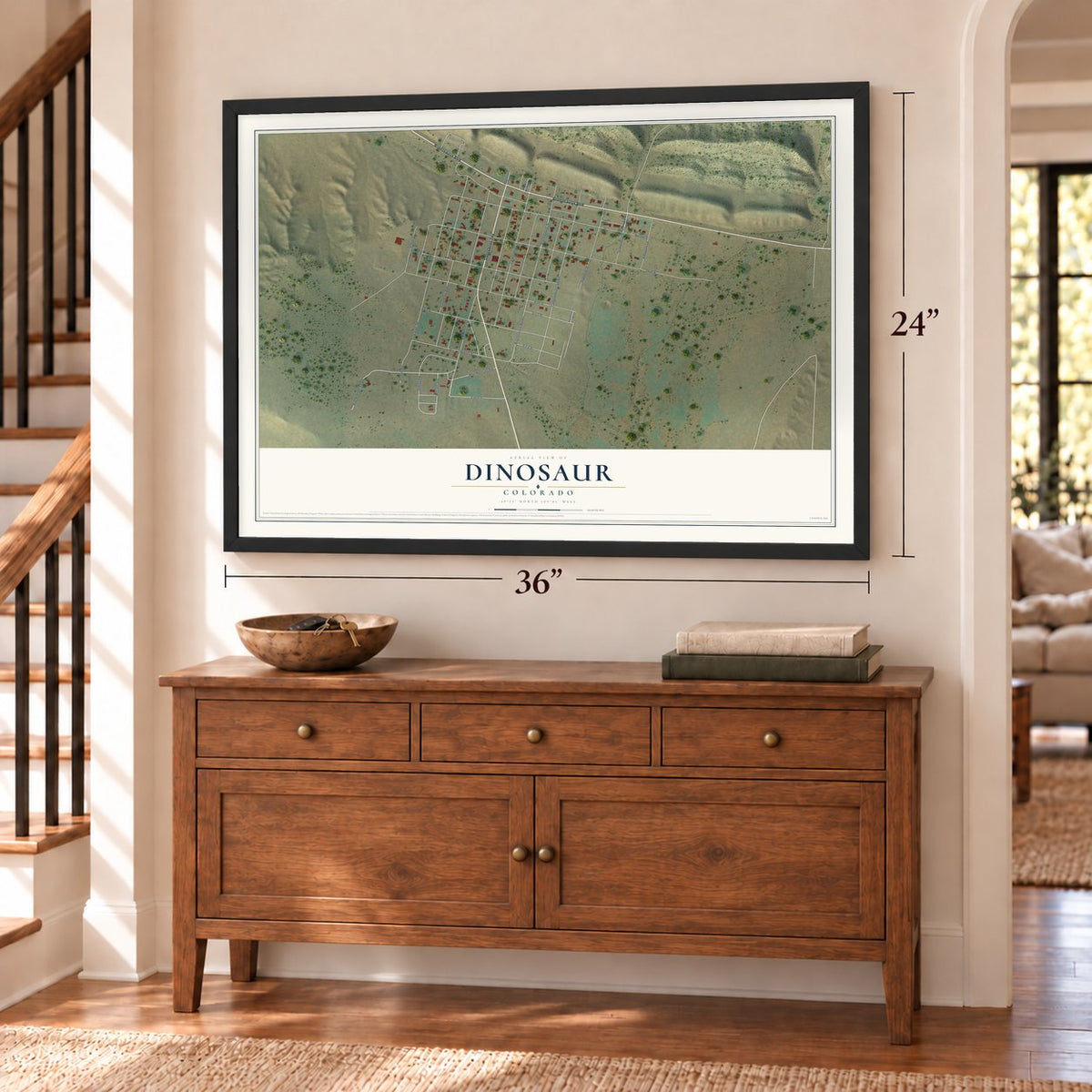 Dinosaur, Colorado map, 24 x 36 inch print in a black frame above a dresser by a staircase
