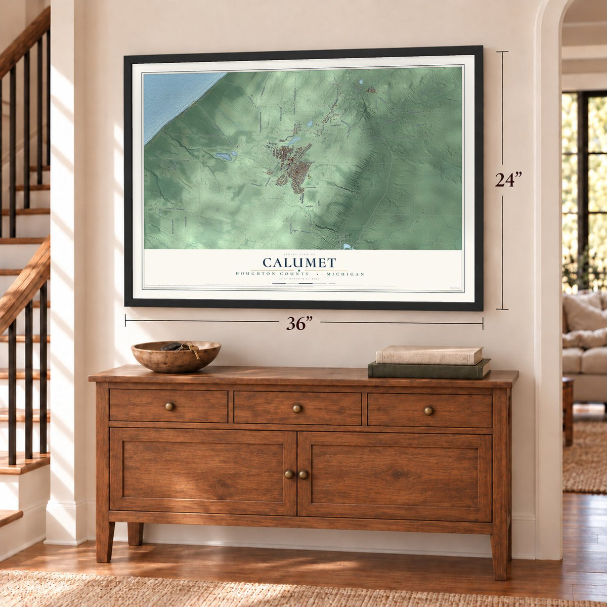Calumet, Houghton County, Michigan map, 24 x 36 inch print in a black frame above a dresser by a staircase