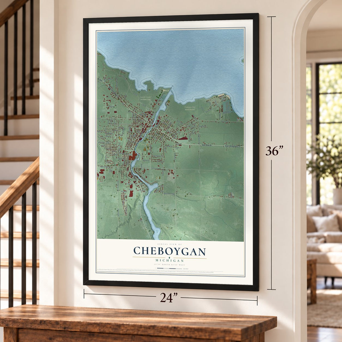 Cheboygan, Michigan map, 24 x 36 inch print in a black frame by a staircase