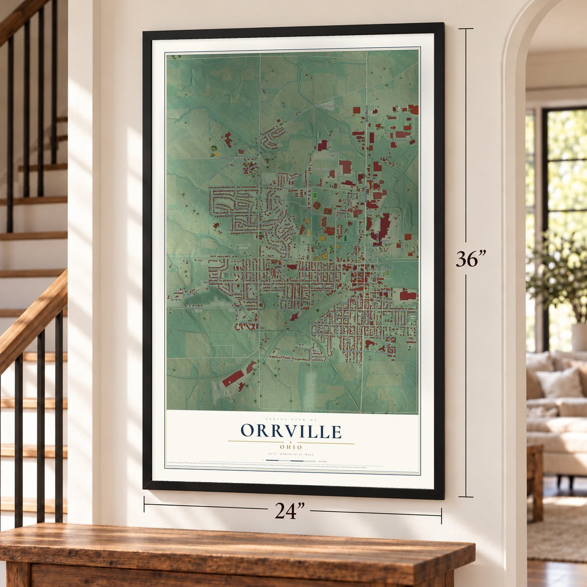 Orrville, Ohio map, 24 x 36 inch print in a black frame by a staircase