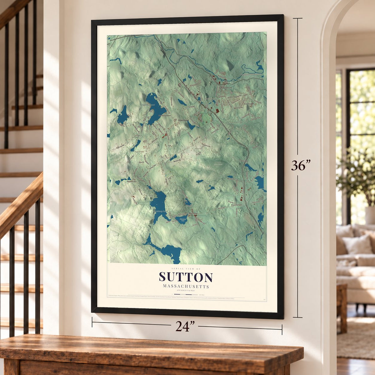 Sutton, Massachusetts map, 24 x 36 inch print in a black frame by a staircase