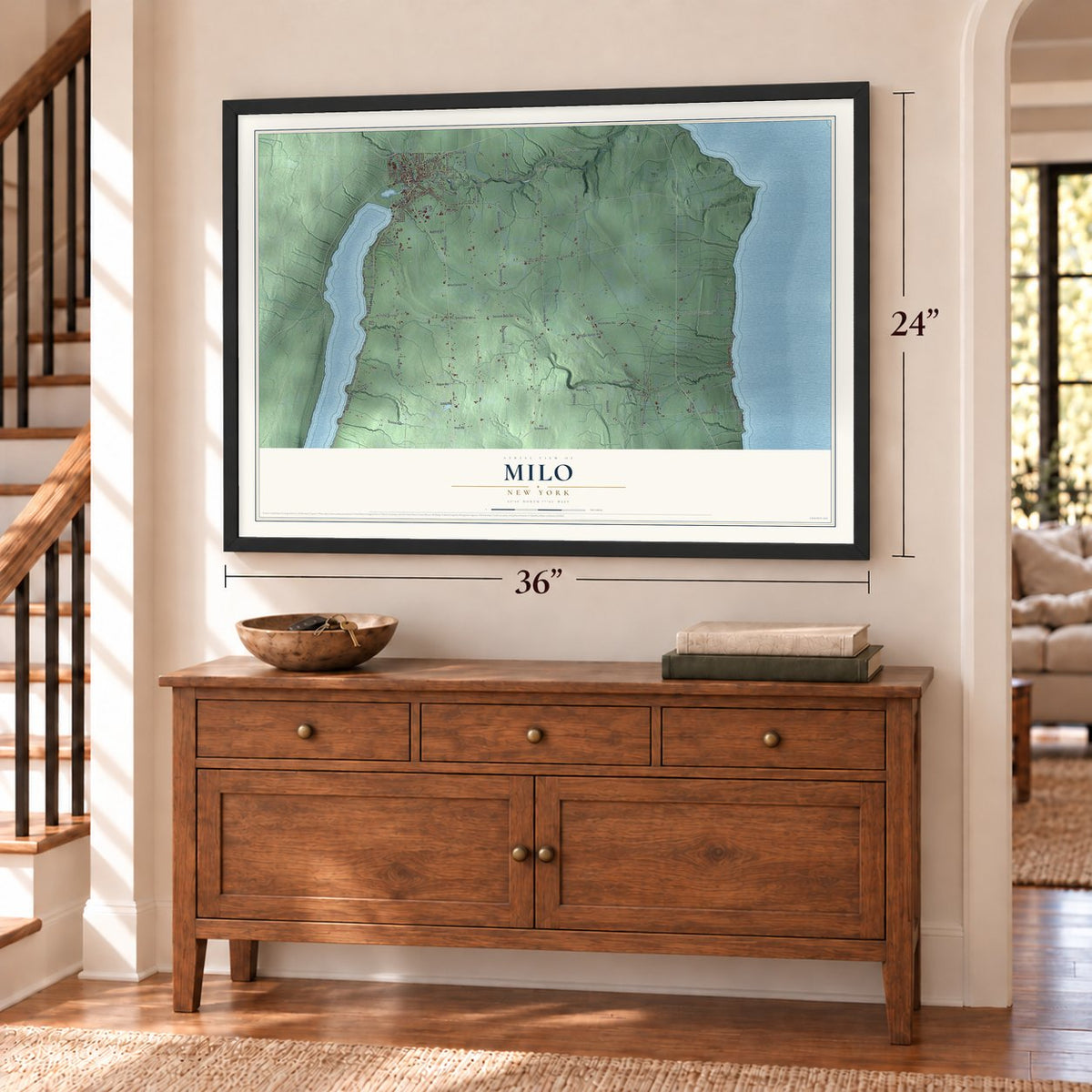 Milo, New York map, 24 x 36 inch print in a black frame above a dresser by a staircase