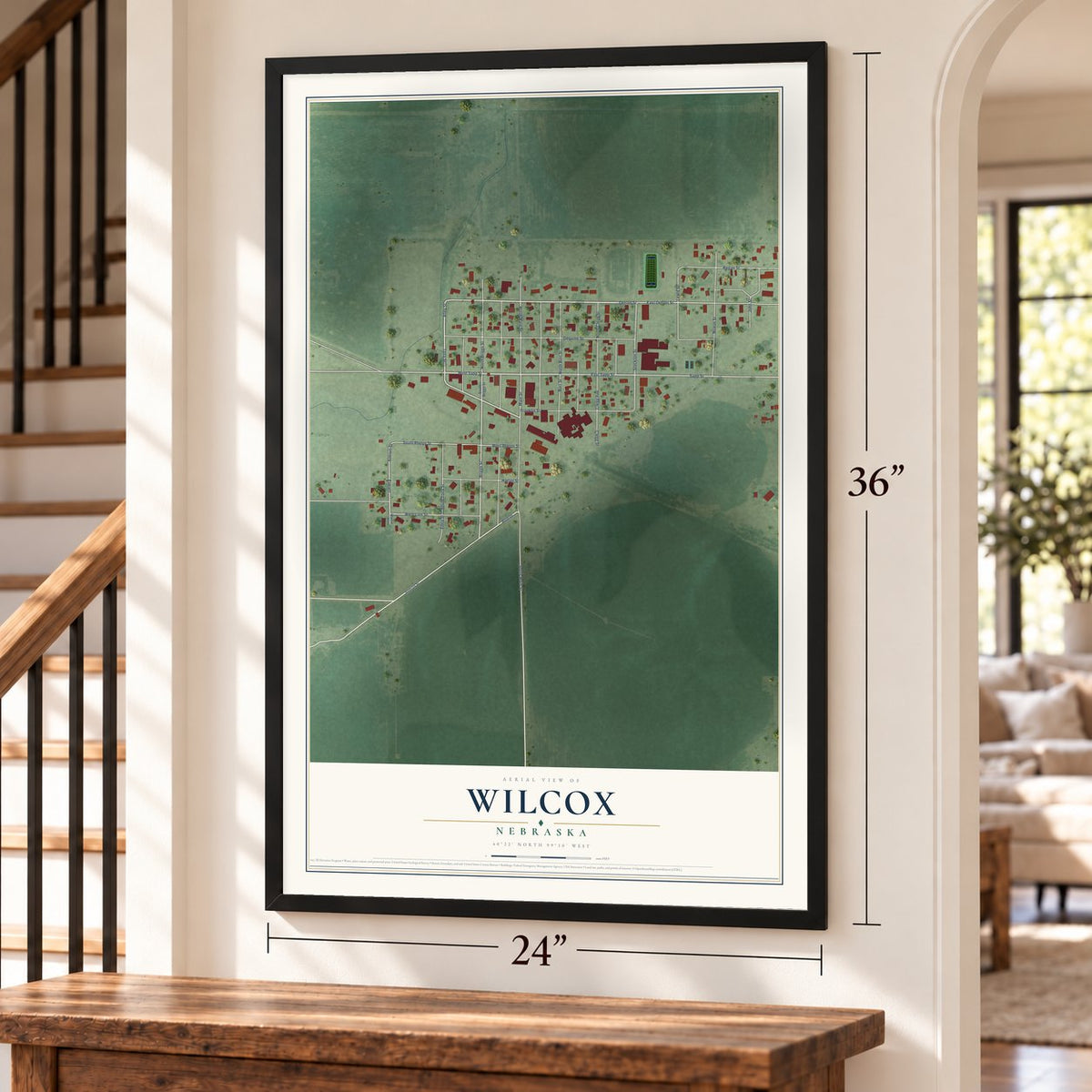Wilcox, Nebraska map, 24 x 36 inch print in a black frame by a staircase