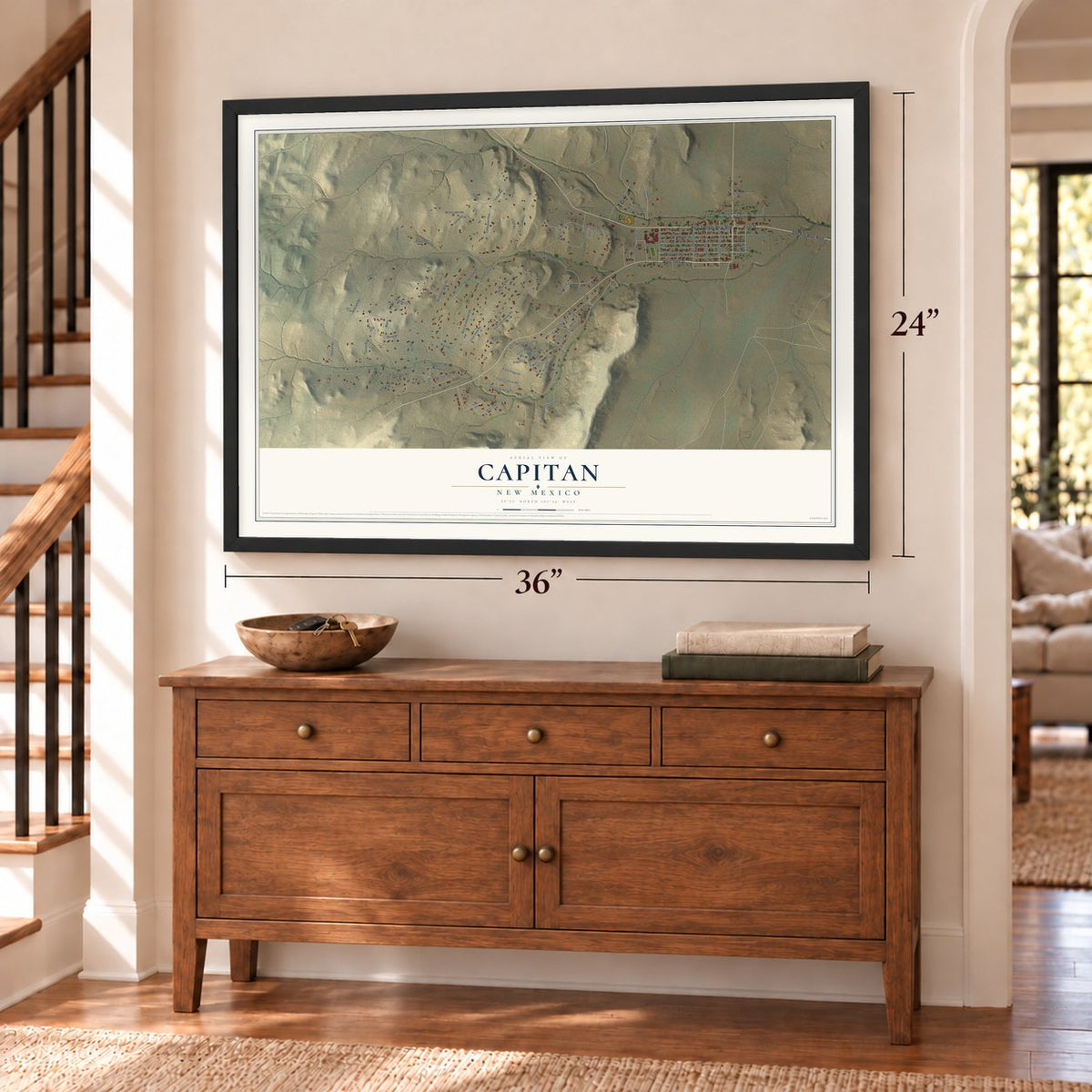 Capitan, New Mexico map, 24 x 36 inch print in a black frame above a dresser by a staircase