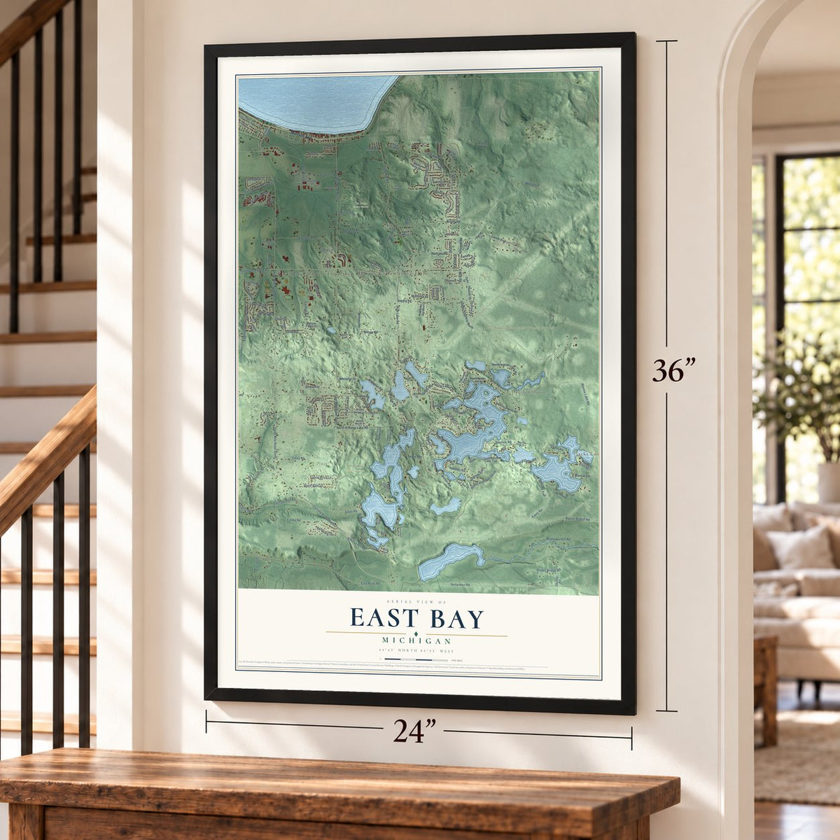 East Bay, Michigan map, 24 x 36 inch print in a black frame by a staircase