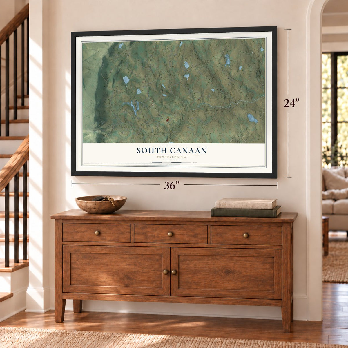 South Canaan, Pennsylvania map, 24 x 36 inch print in a black frame above a dresser by a staircase