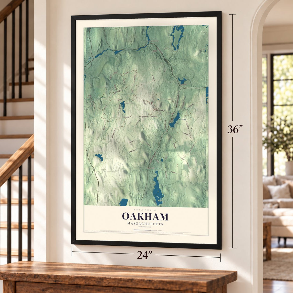 Oakham, Massachusetts map, 24 x 36 inch print in a black frame by a staircase