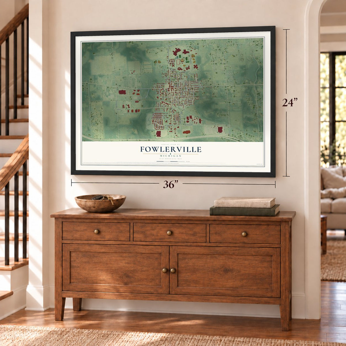 Fowlerville, Michigan map, 24 x 36 inch print in a black frame above a dresser by a staircase