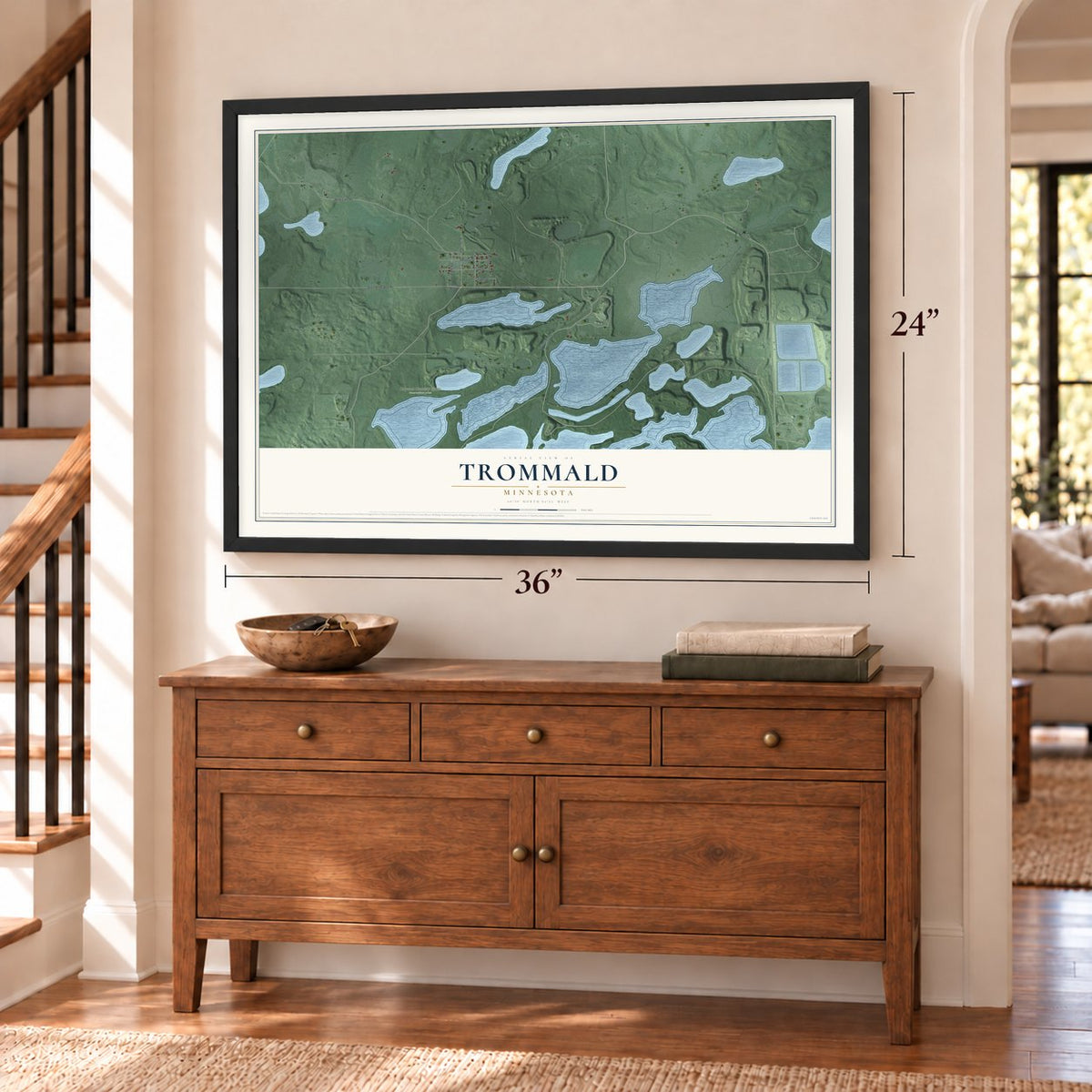 Trommald, Minnesota map, 24 x 36 inch print in a black frame above a dresser by a staircase