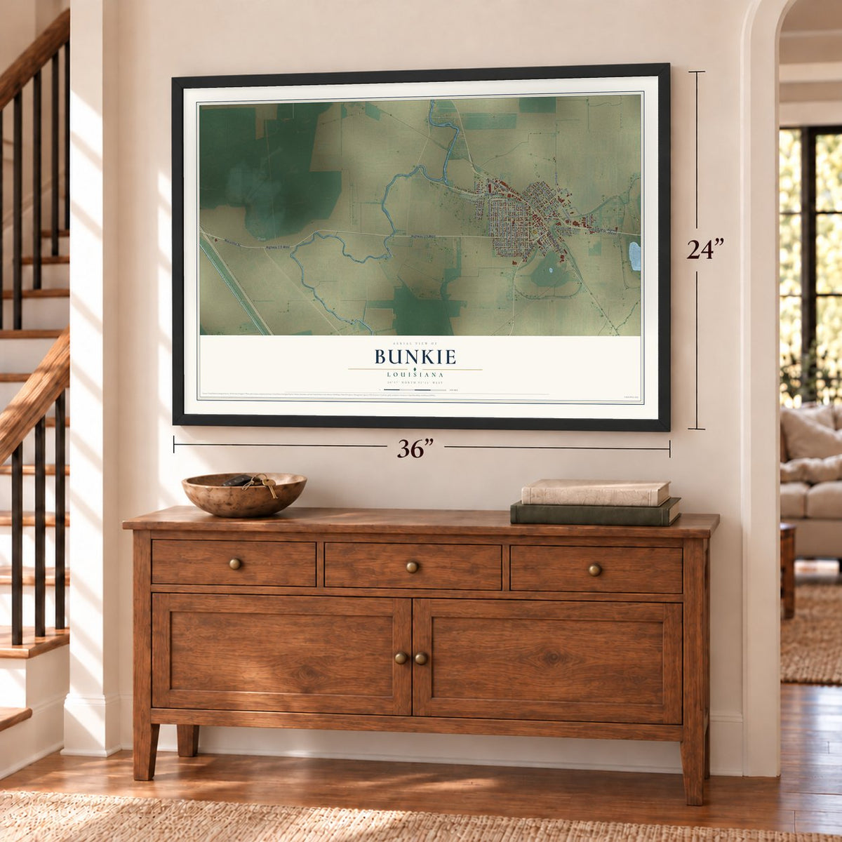 Bunkie, Louisiana map, 24 x 36 inch print in a black frame above a dresser by a staircase
