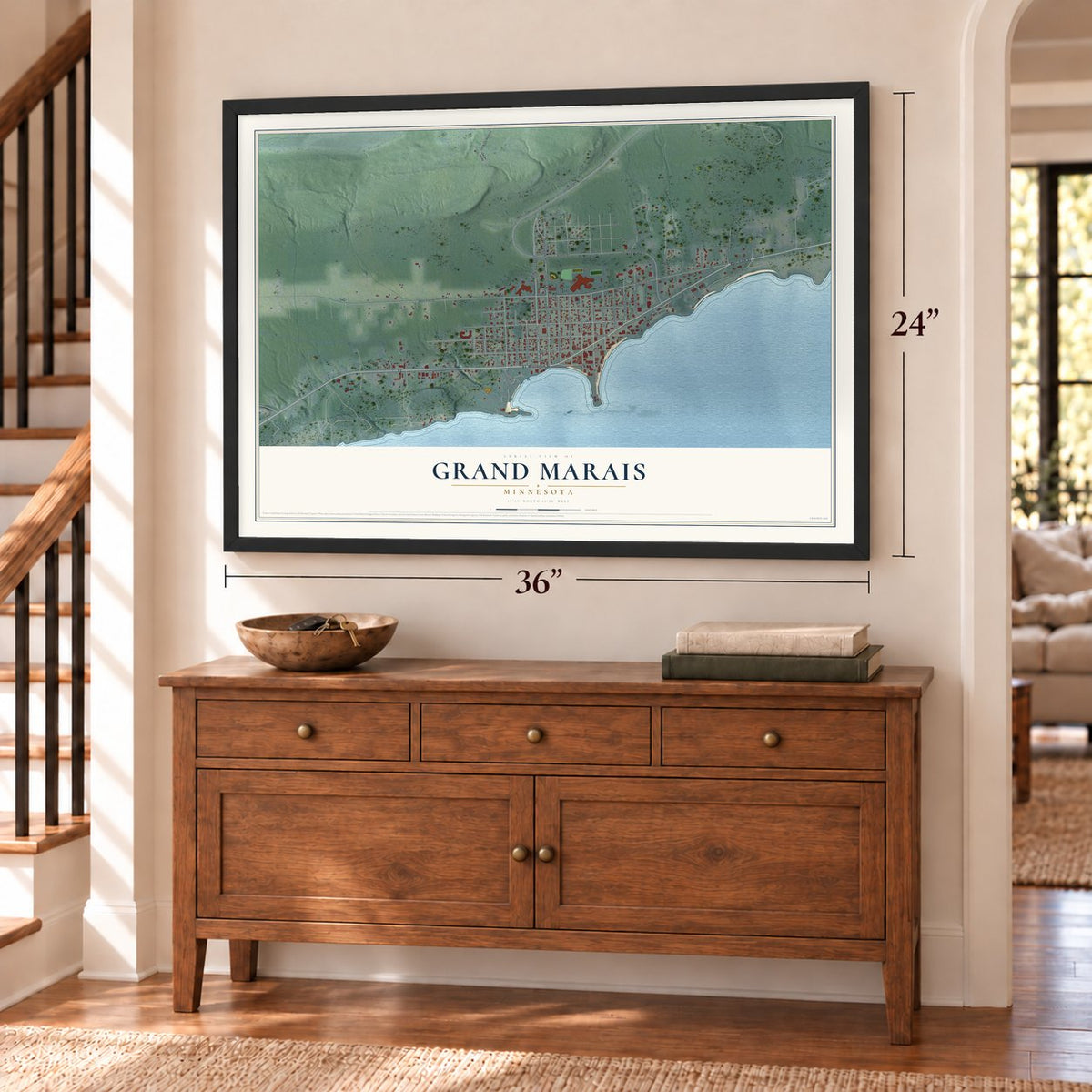 Grand Marais, Minnesota map, 24 x 36 inch print in a black frame above a dresser by a staircase