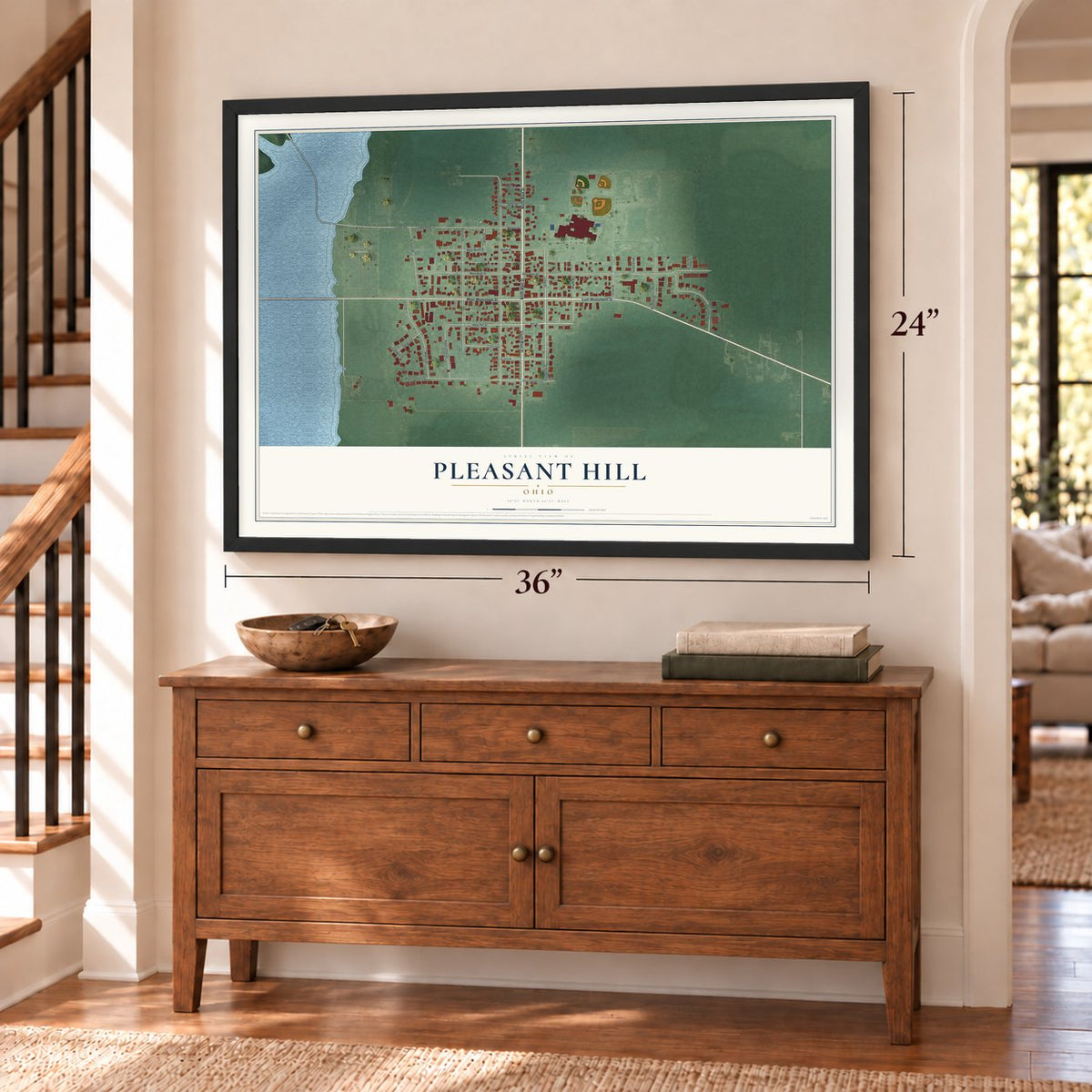 Pleasant Hill, Ohio map, 24 x 36 inch print in a black frame above a dresser by a staircase