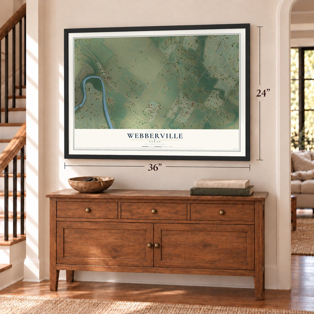 Webberville, Texas map, 24 x 36 inch print in a black frame above a dresser by a staircase