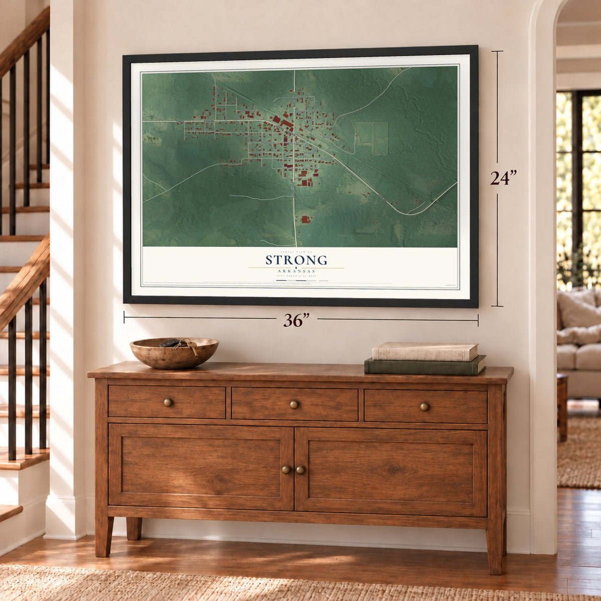 Strong, Arkansas map, 24 x 36 inch print in a black frame above a dresser by a staircase