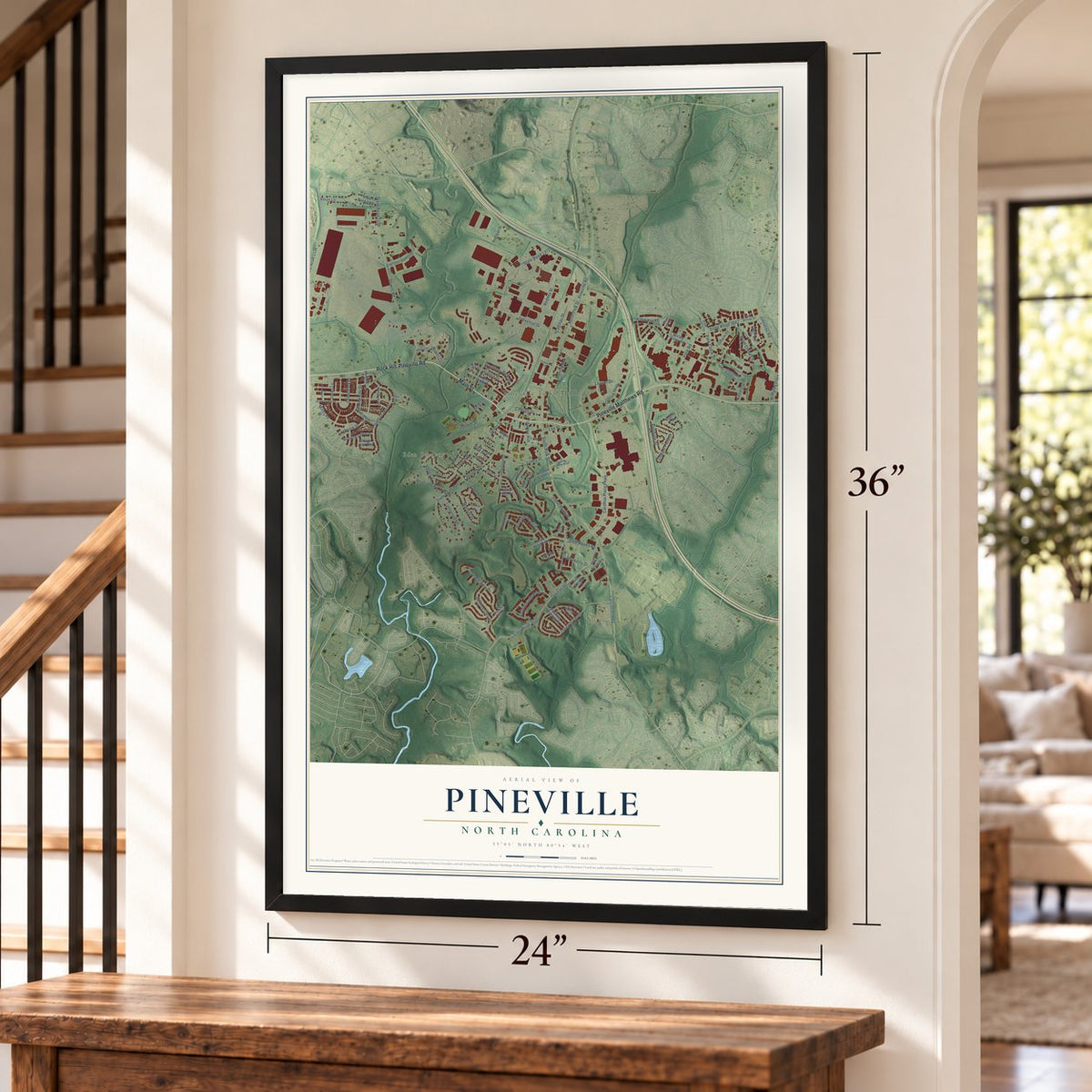 Pineville, North Carolina map, 24 x 36 inch print in a black frame by a staircase
