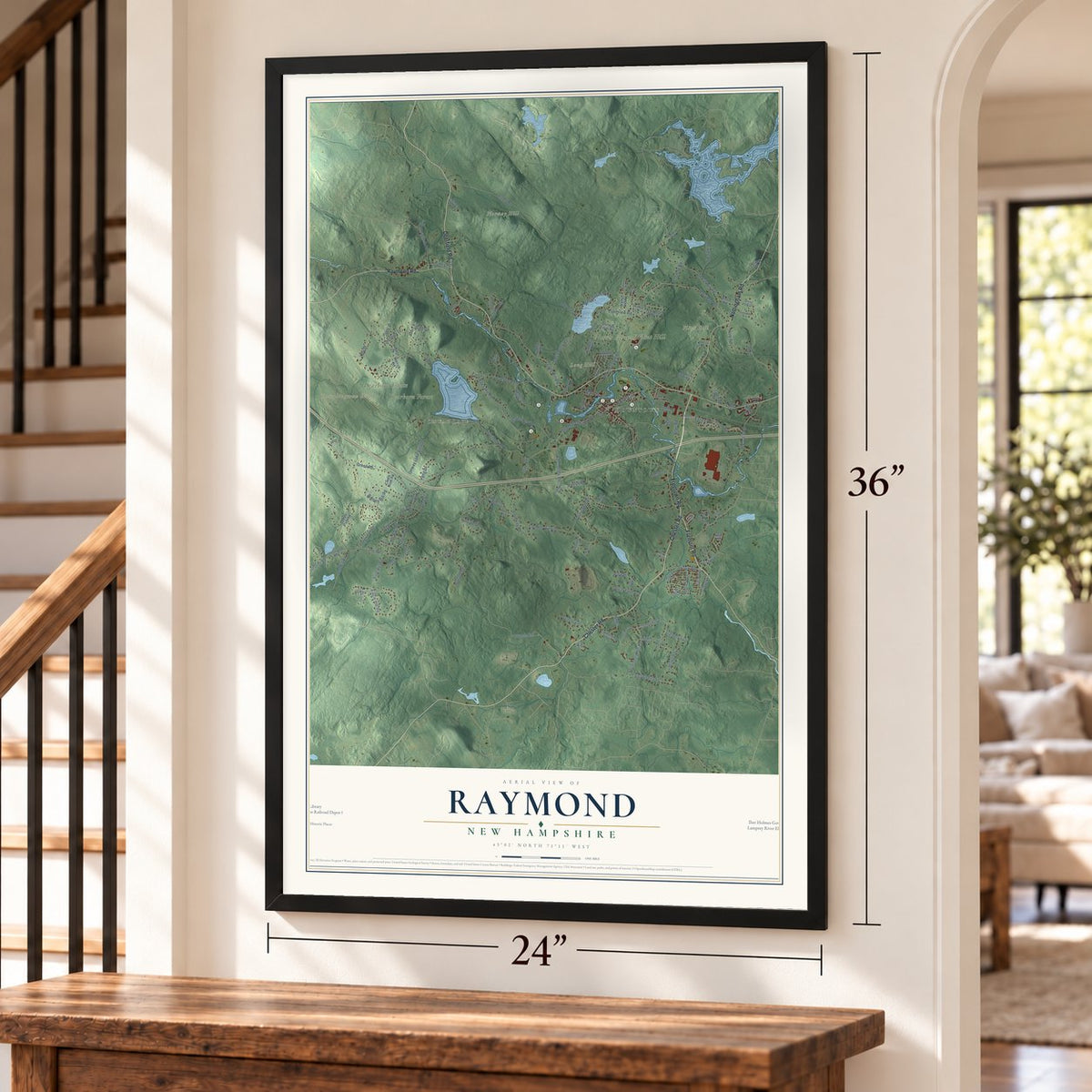Raymond, New Hampshire map, 24 x 36 inch print in a black frame by a staircase