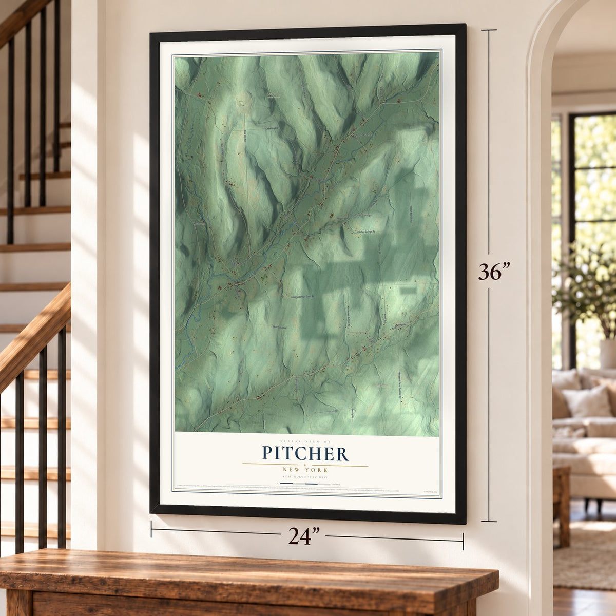 Pitcher, New York map, 24 x 36 inch print in a black frame by a staircase