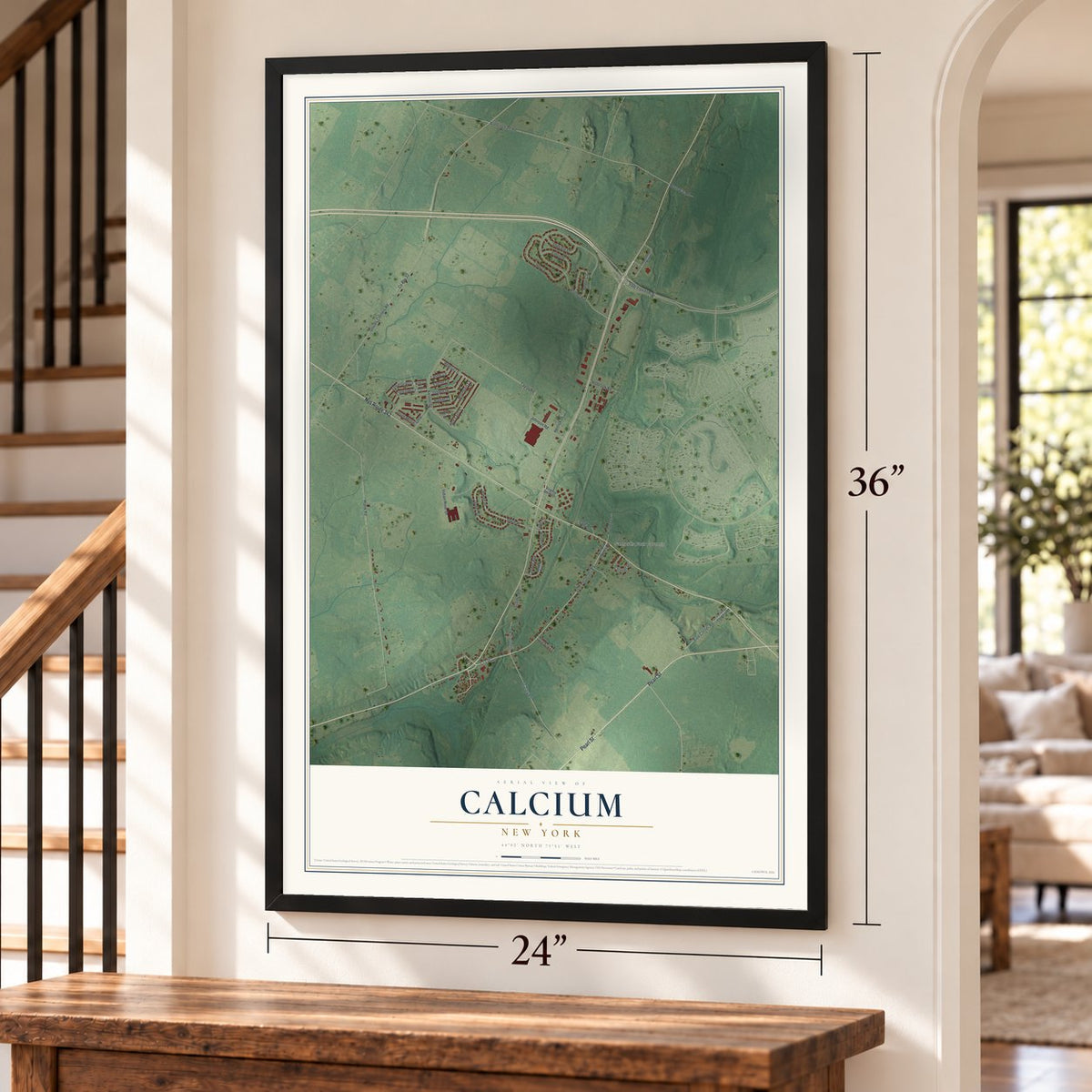 Calcium, New York map, 24 x 36 inch print in a black frame by a staircase
