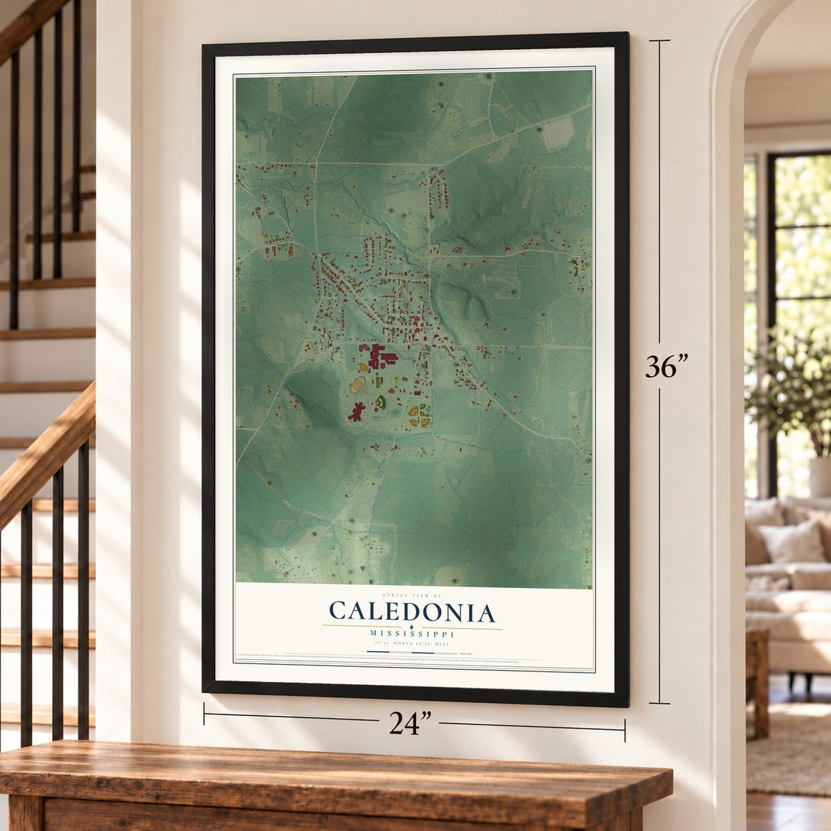 Caledonia, Mississippi map, 24 x 36 inch print in a black frame by a staircase