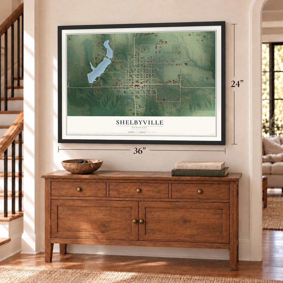 Shelbyville, Missouri map, 24 x 36 inch print in a black frame above a dresser by a staircase